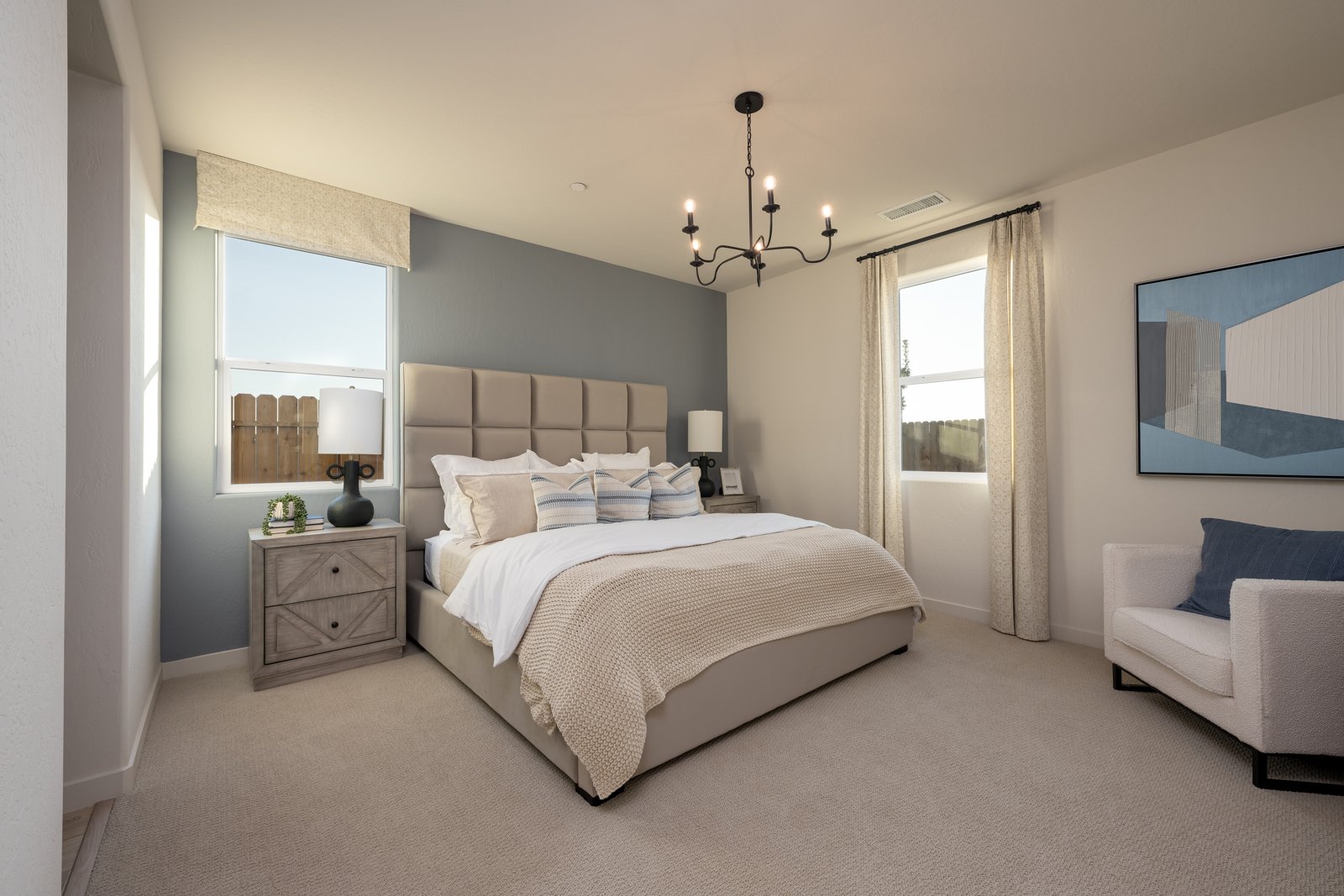 A bedroom with a bed and a chair.