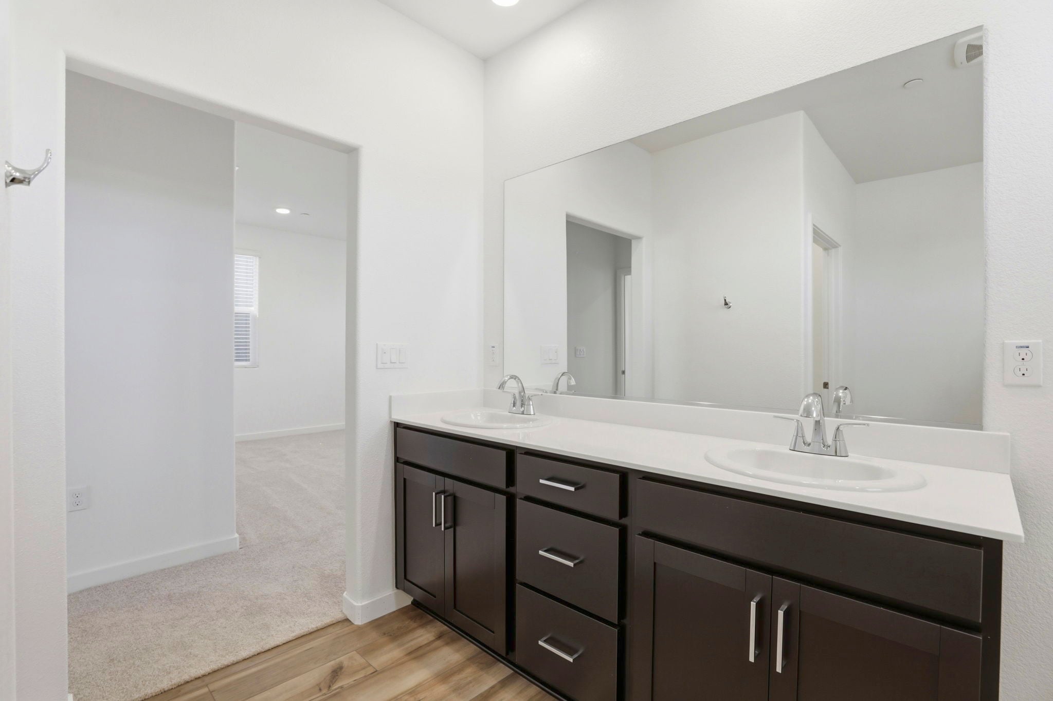 A bathroom with a large mirror.