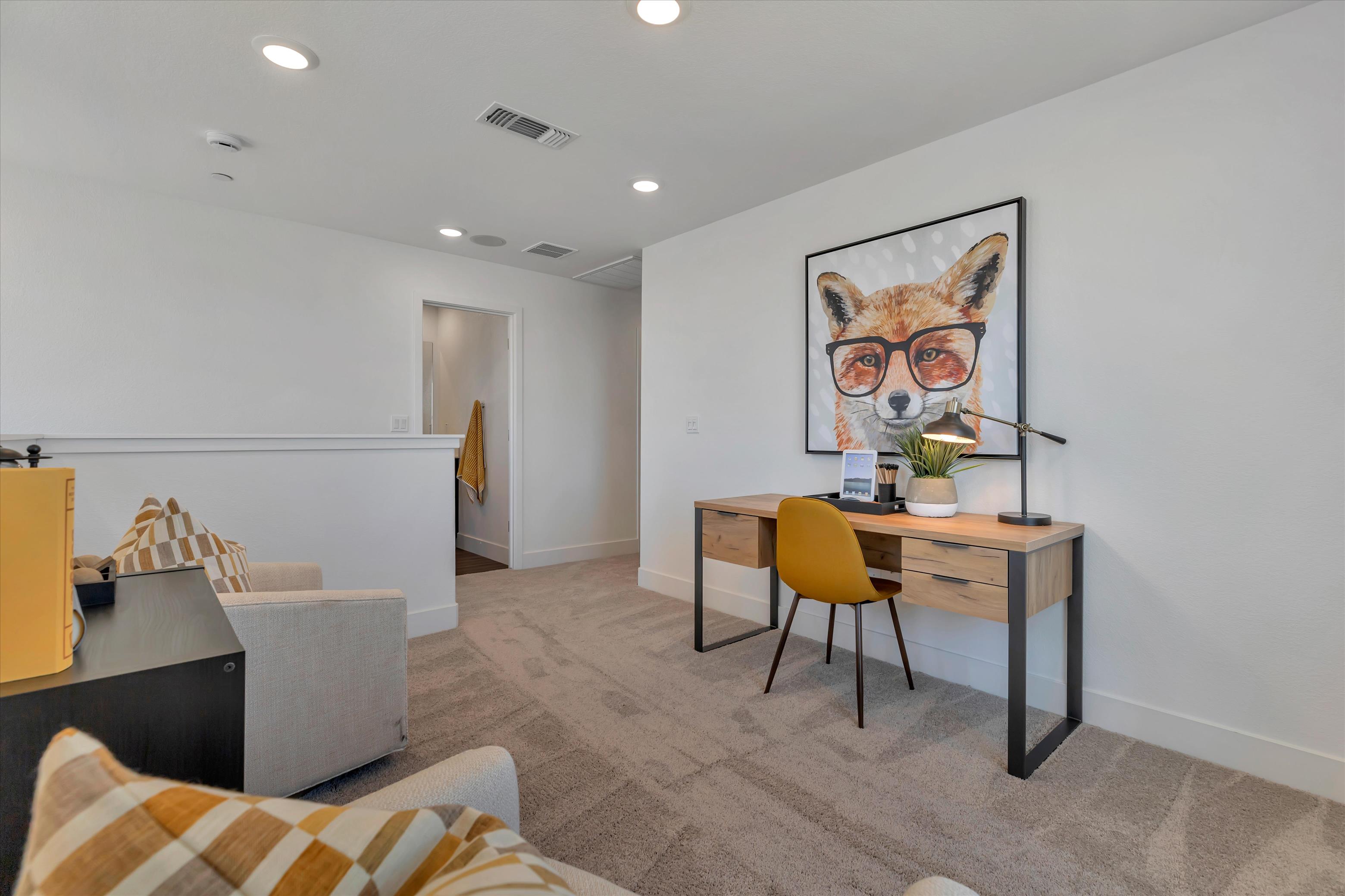 A room with a desk and chairs.