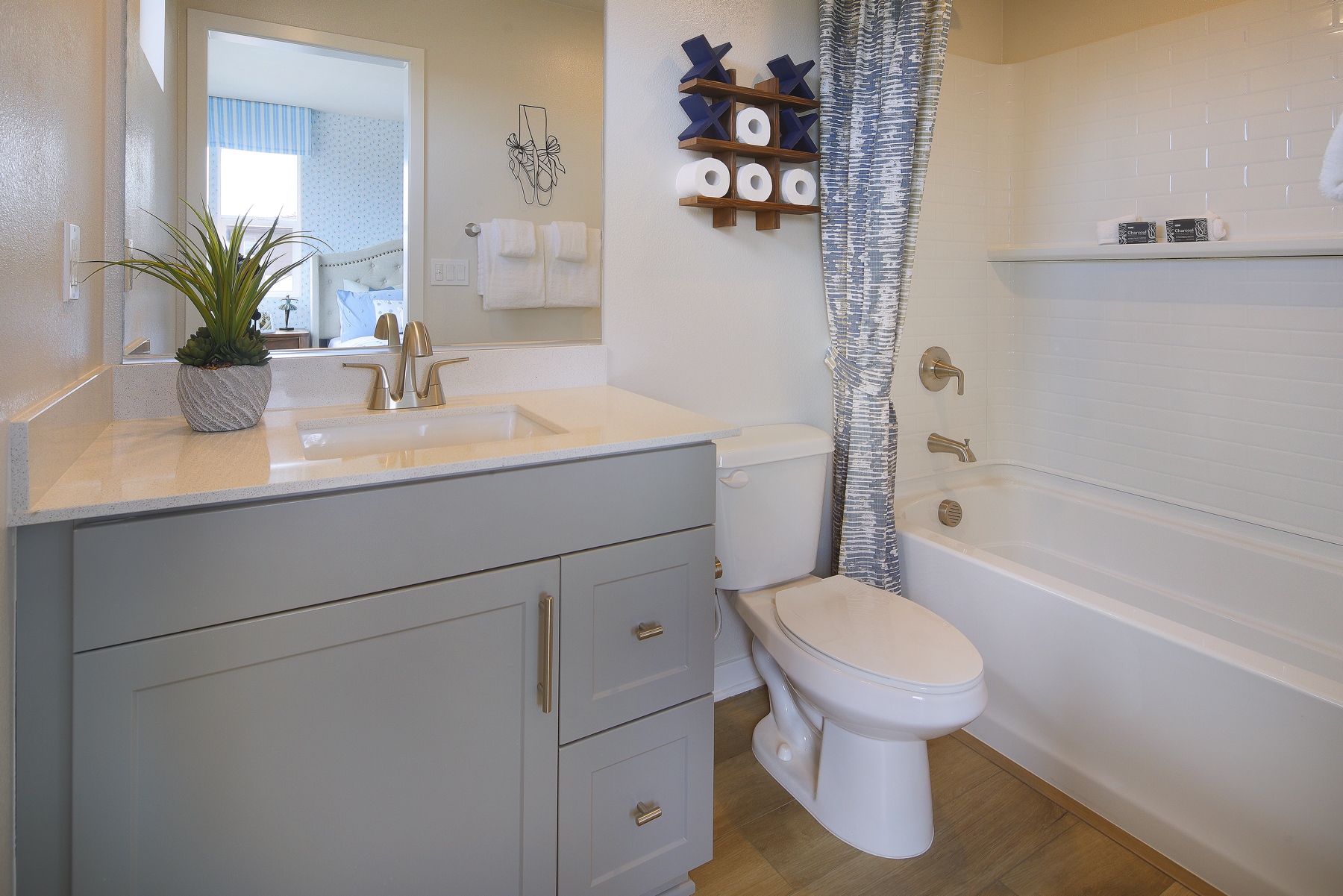 A bathroom with a sink toilet and bathtub.