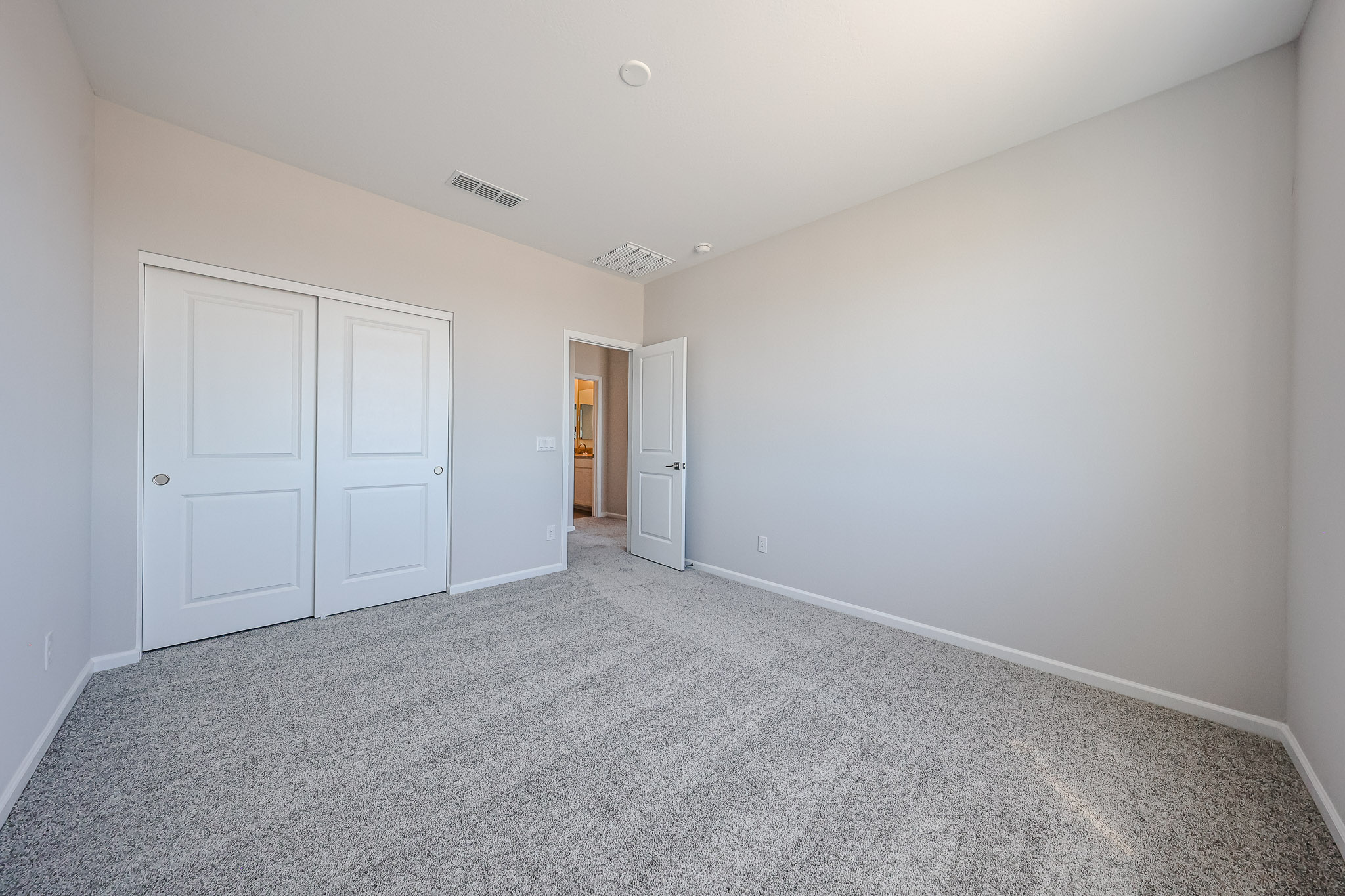 A hallway with white doors.