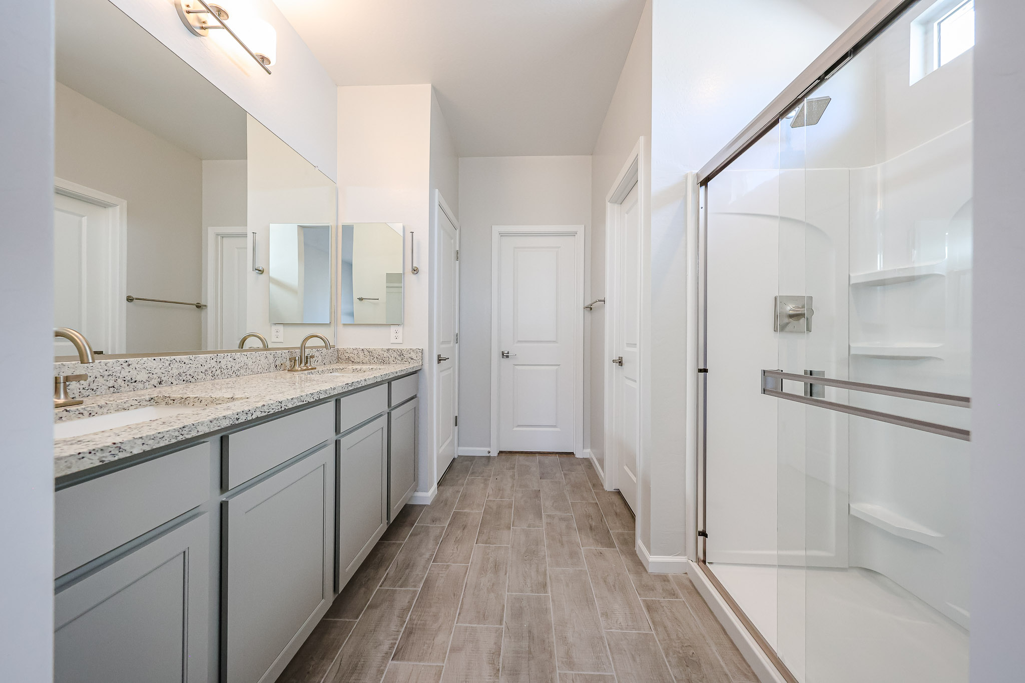 A bathroom with white cabinets.