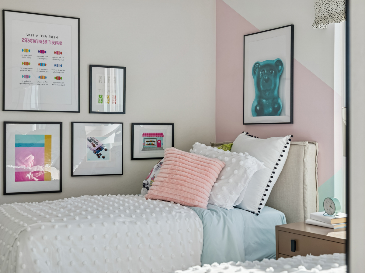 A bed with a white bed spread.