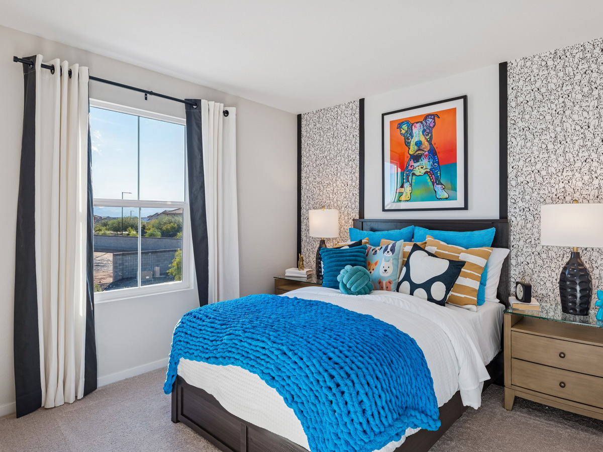 A bedroom with a bed and a window.