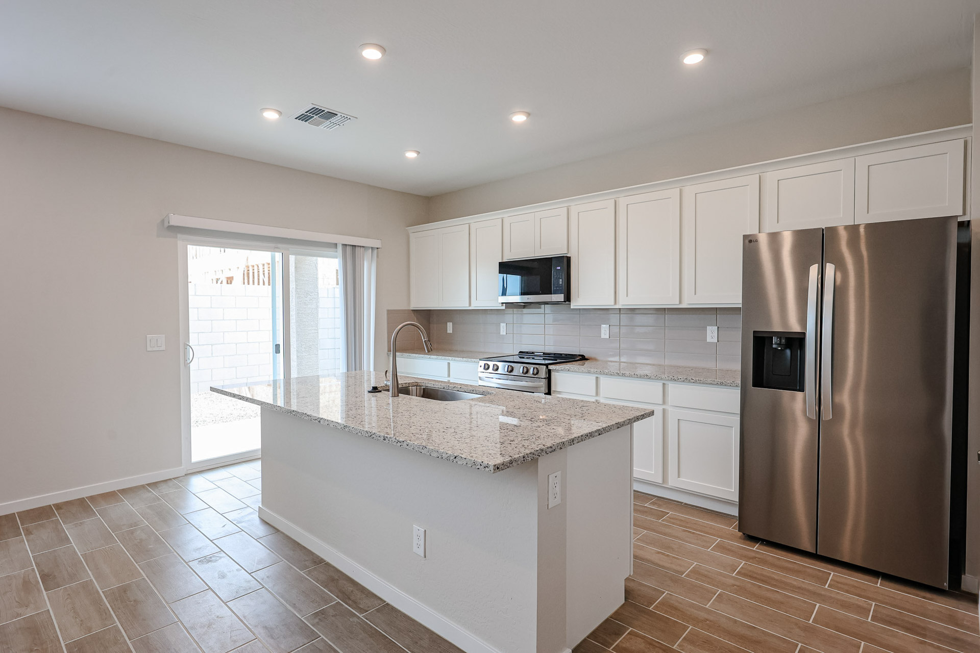 A kitchen with white cabinets.