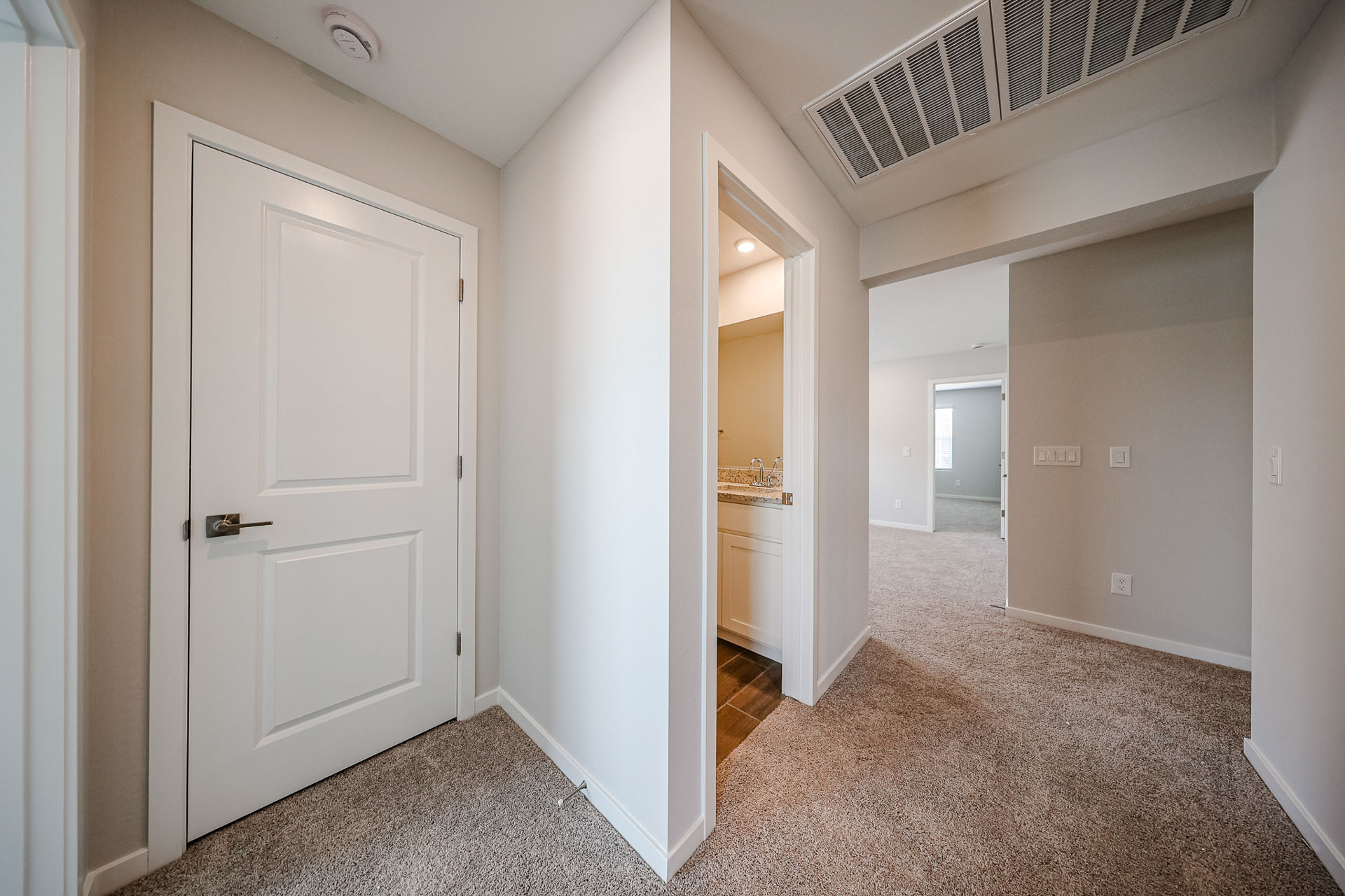 A hallway with white doors.