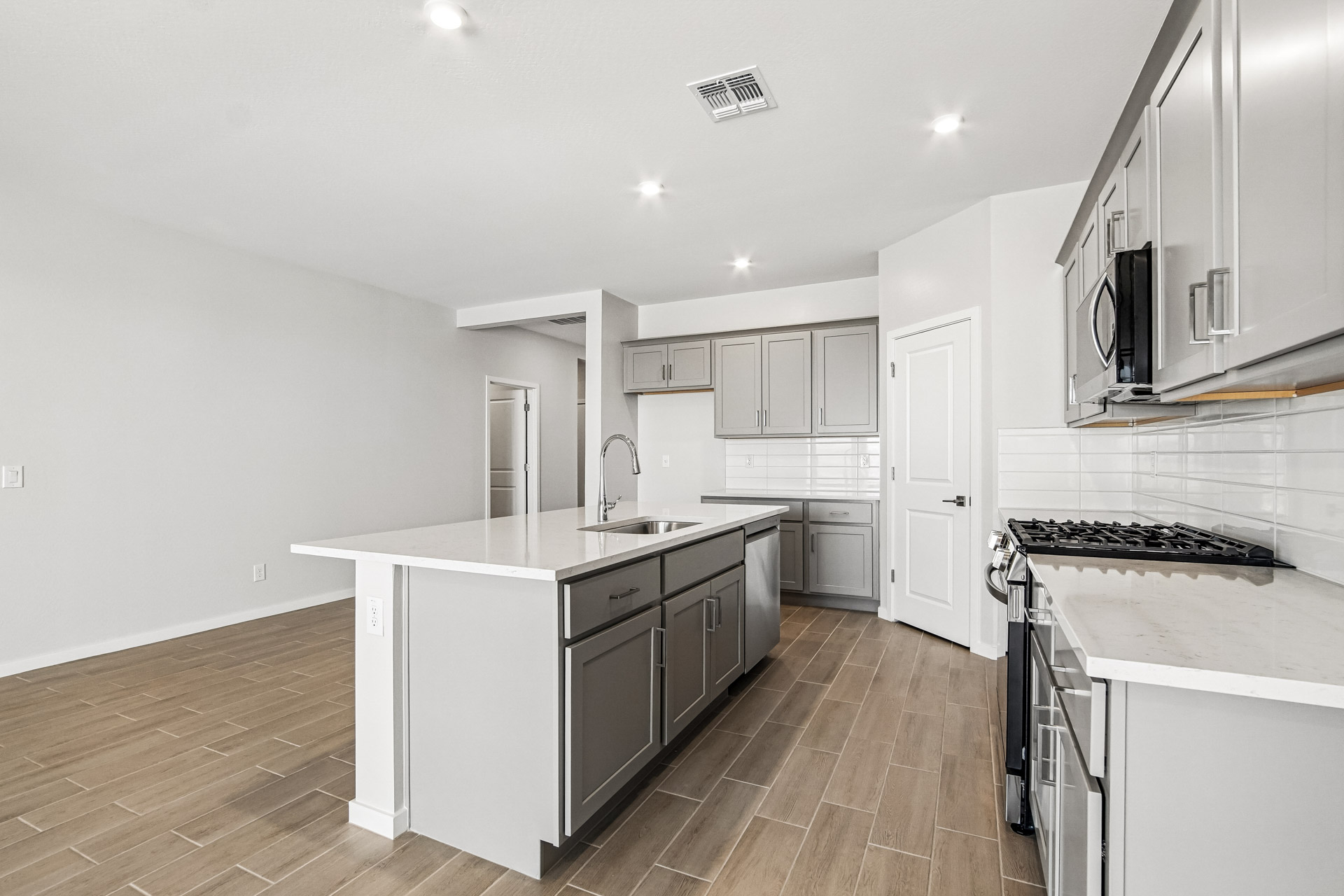 A kitchen with white cabinets.