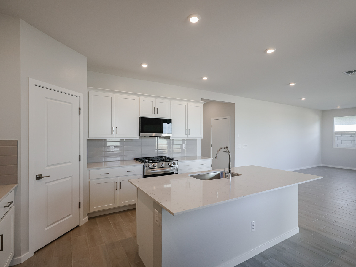 A kitchen with white cabinets.