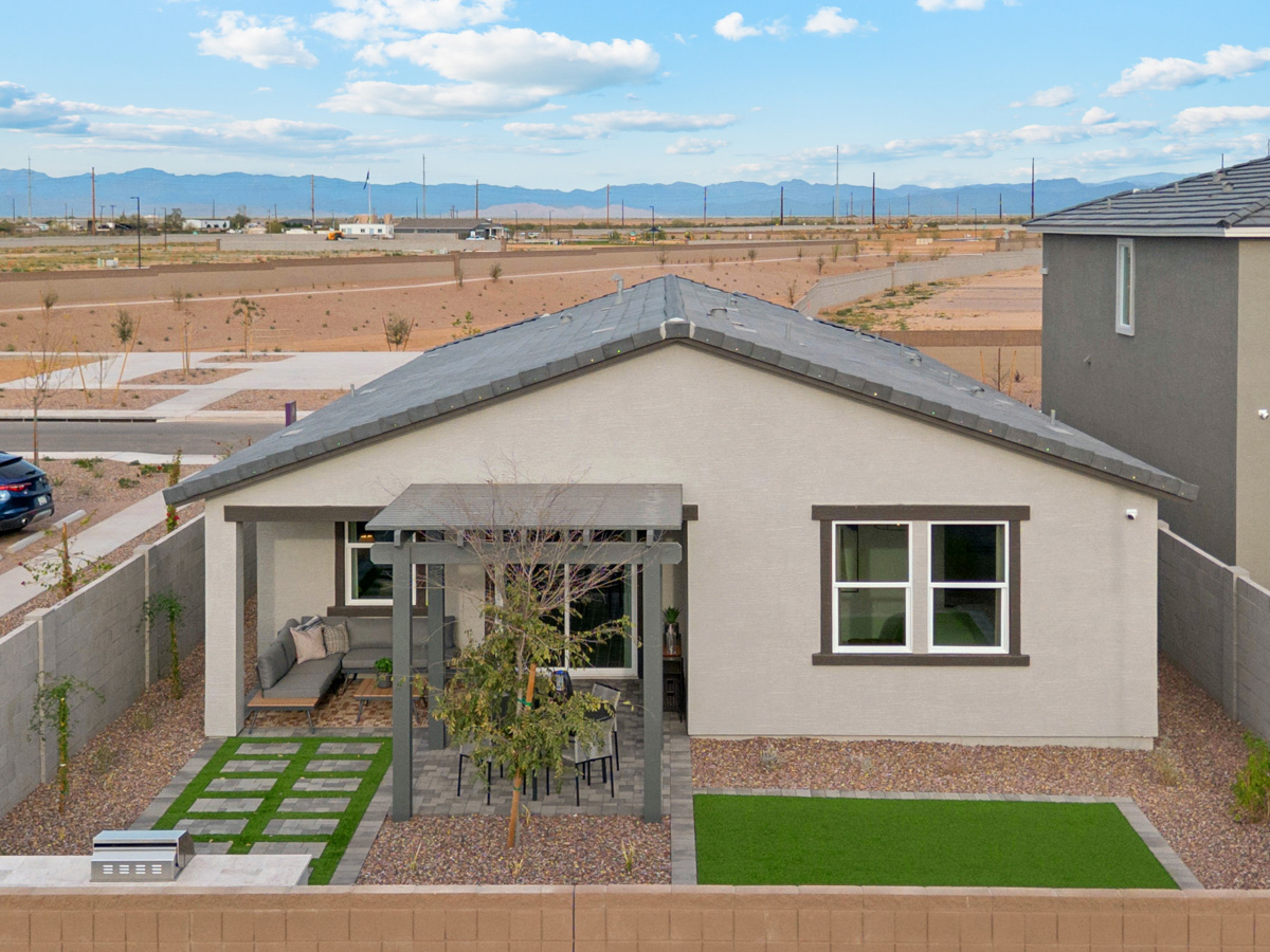 A house with a yard and a tree in the front.