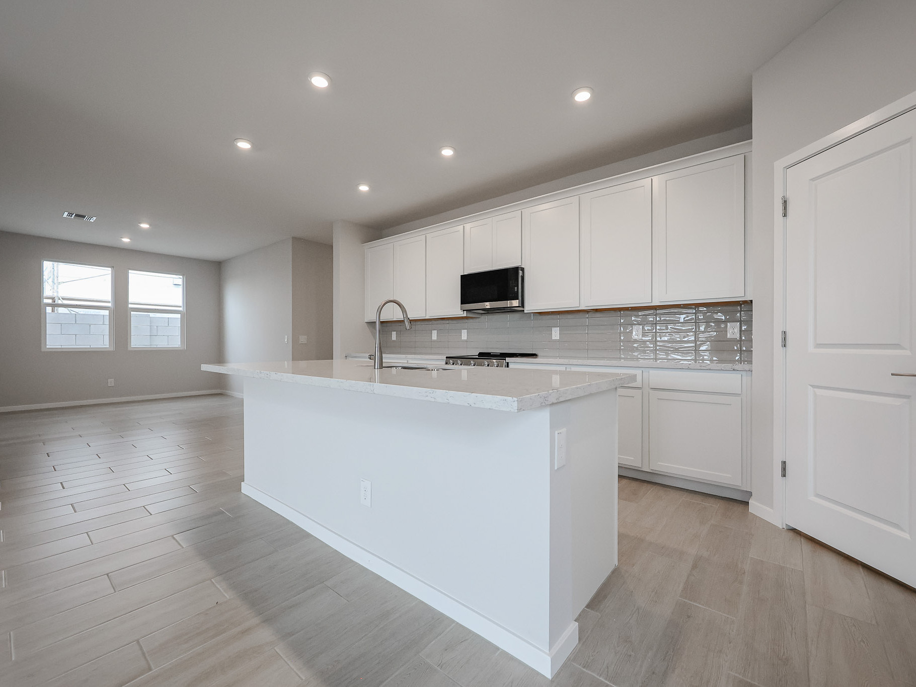 A kitchen with white cabinets.