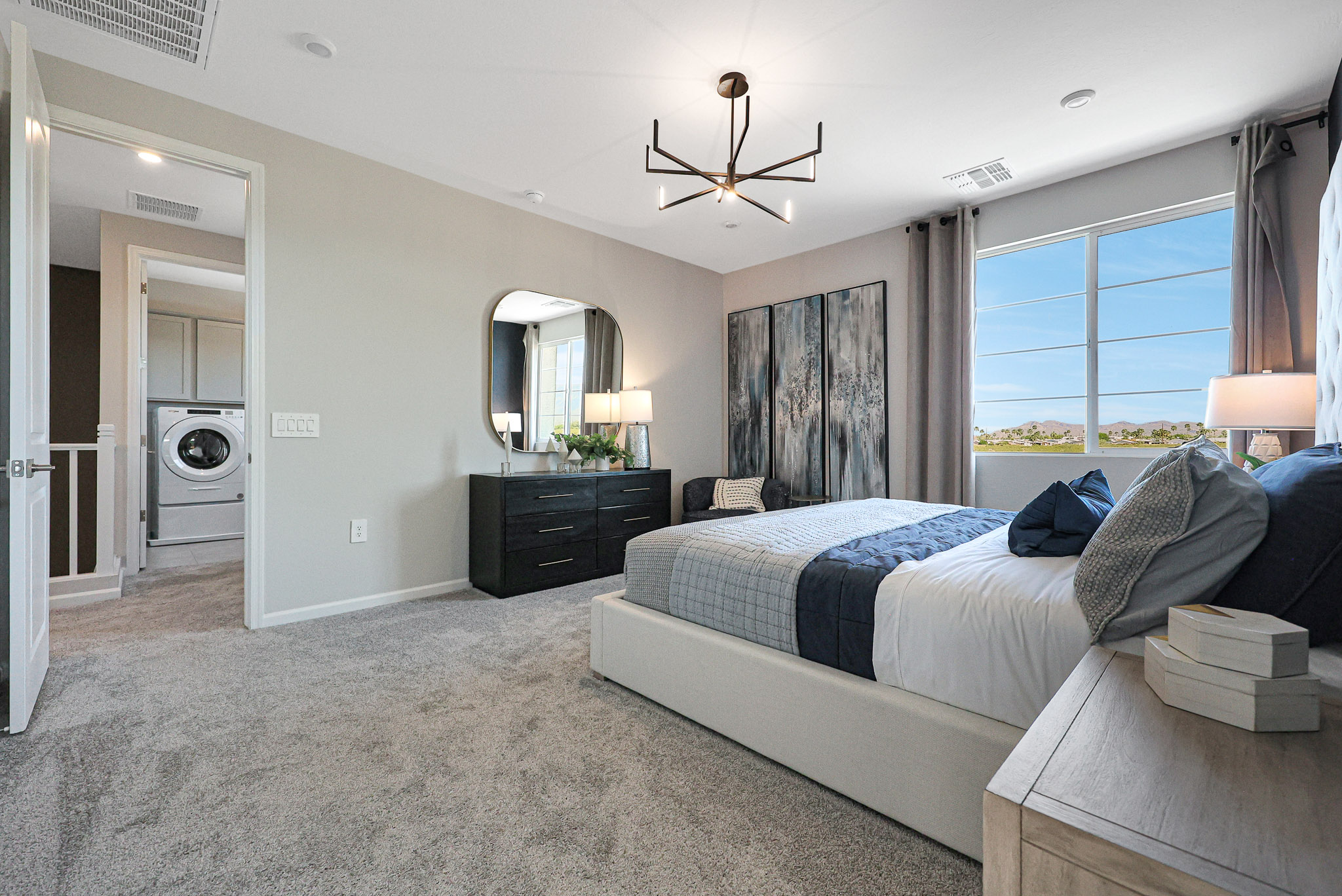 A bedroom with a bed and a table.