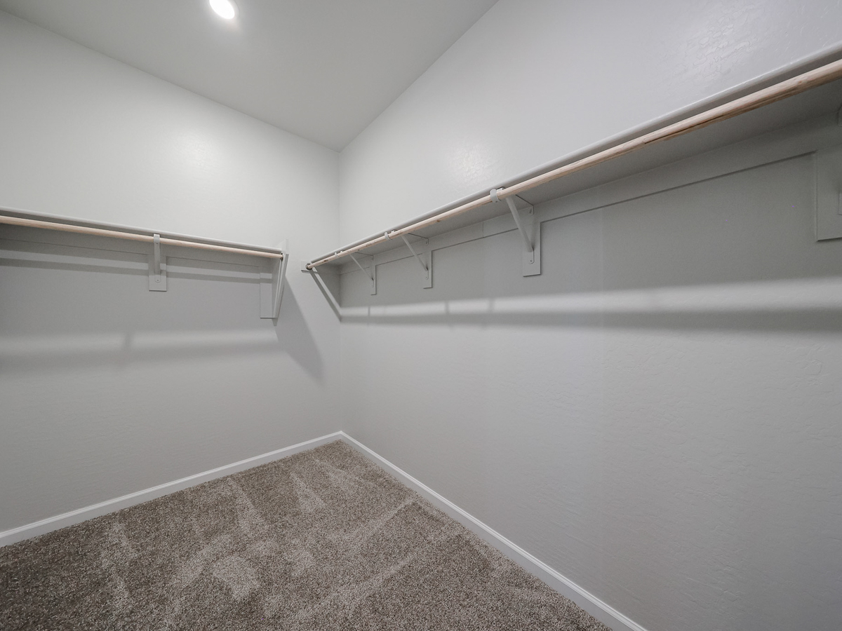 A white wall with a metal railing.