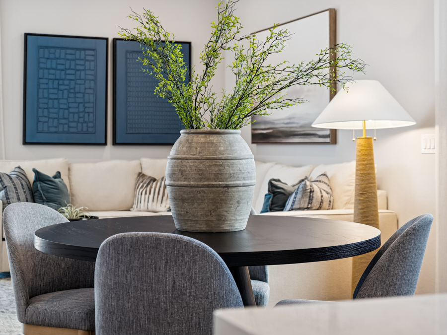 A living room with a table and chairs.