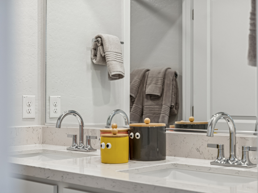 A bathroom with a mirror and towels.