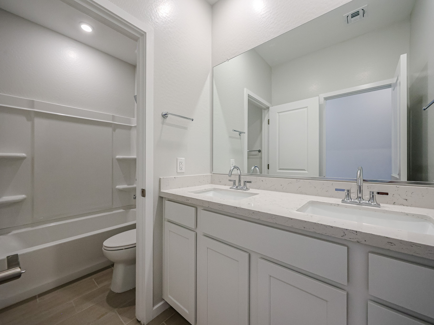 A bathroom with a tub sink and toilet.