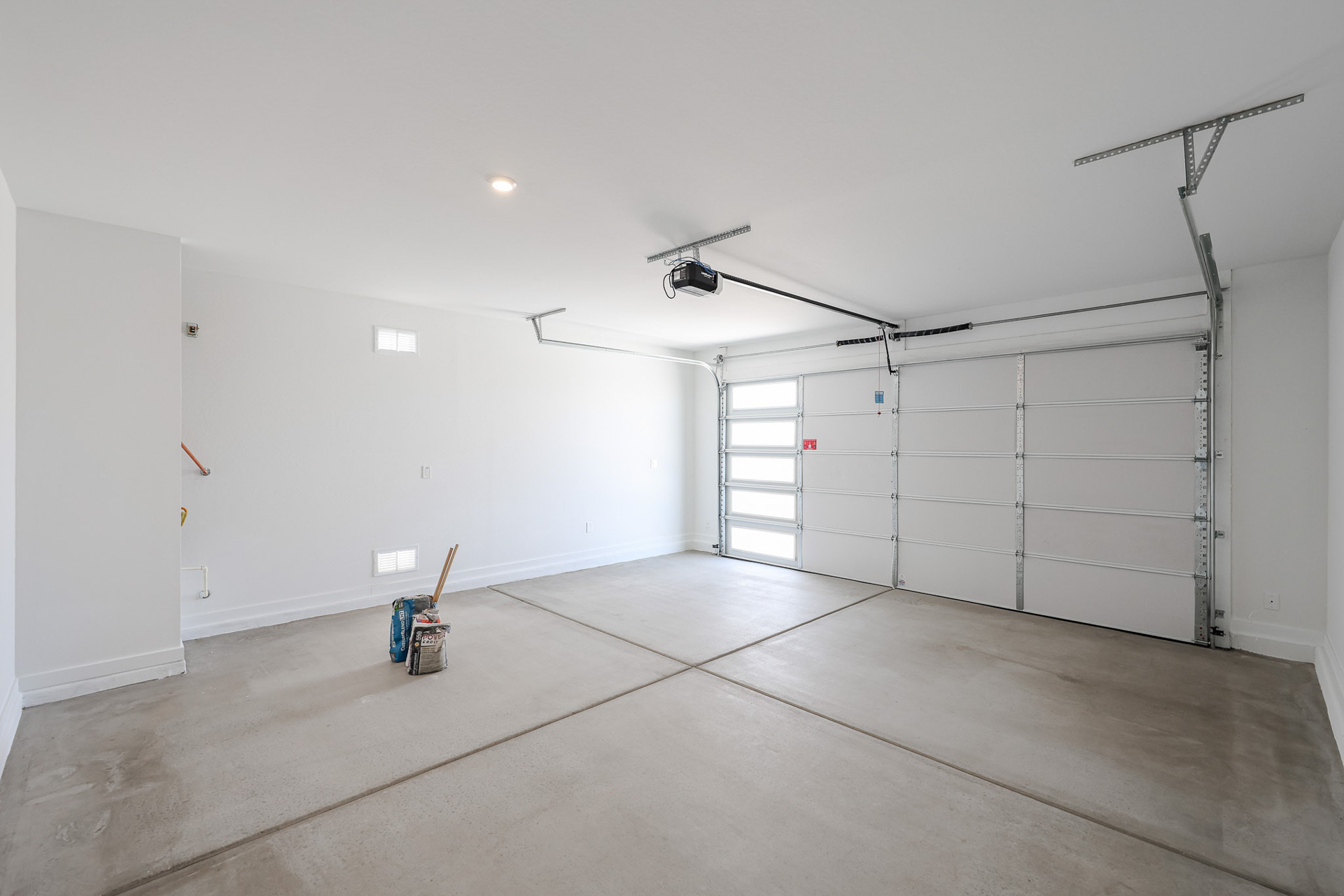 A room with white walls and a light on the ceiling.