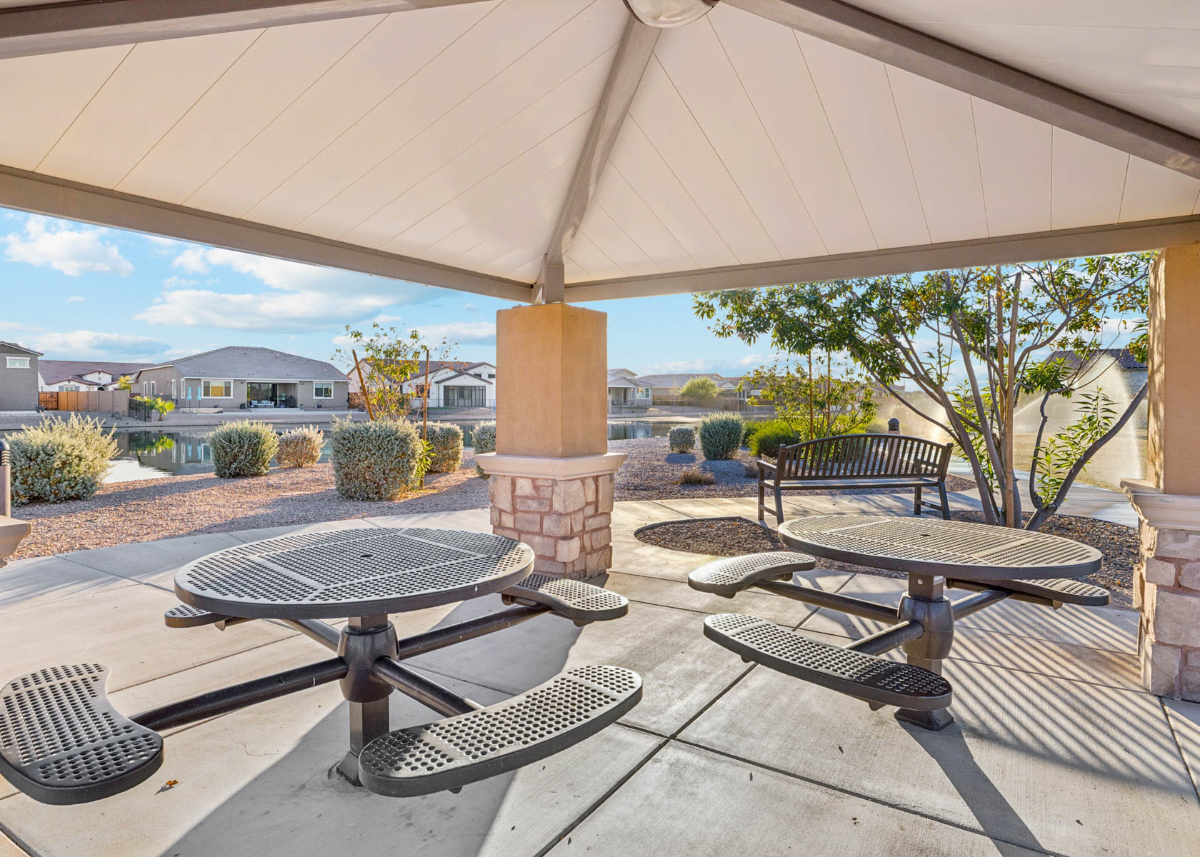 A patio with tables and chairs.