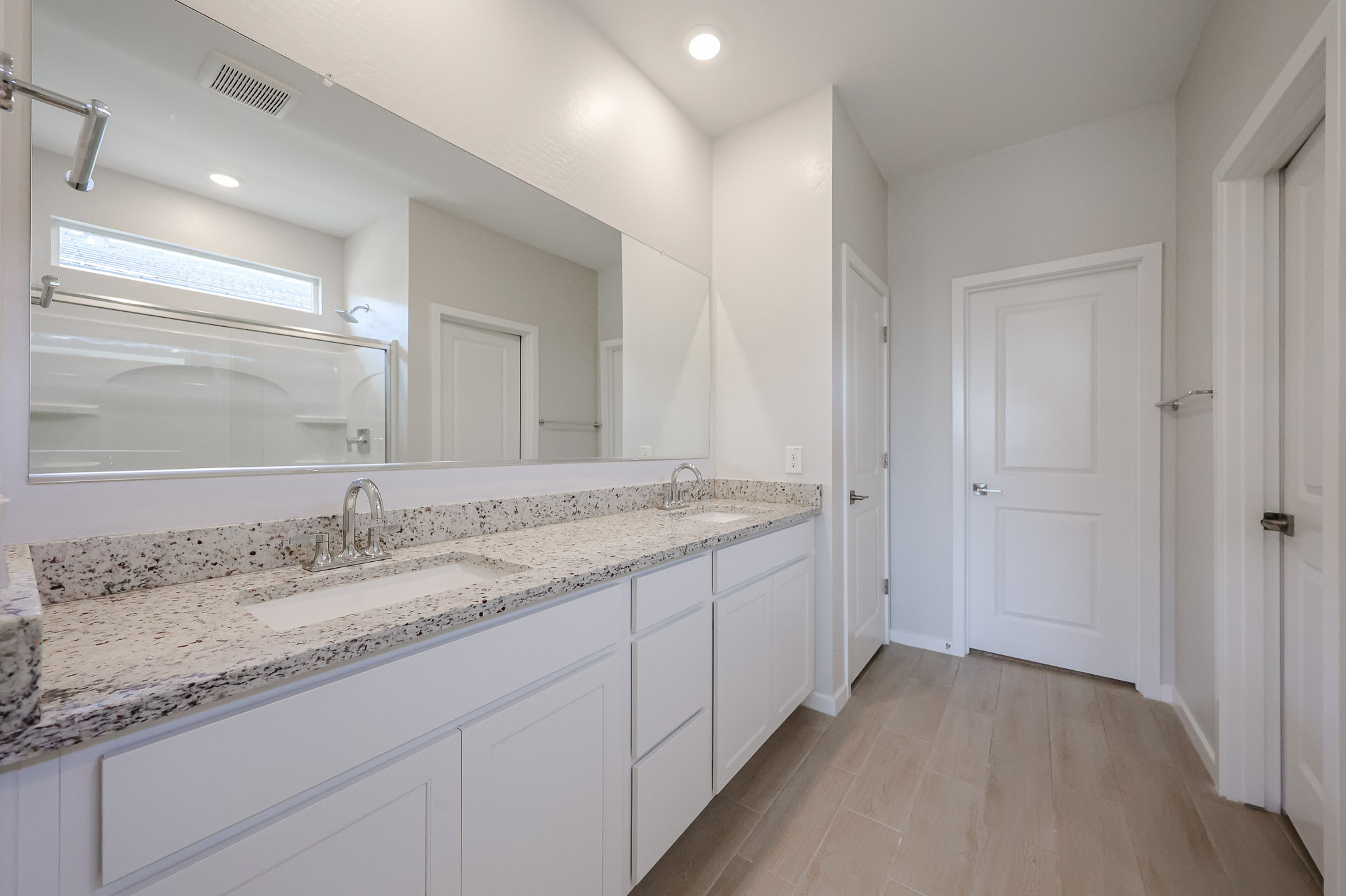 A bathroom with a marble countertop.