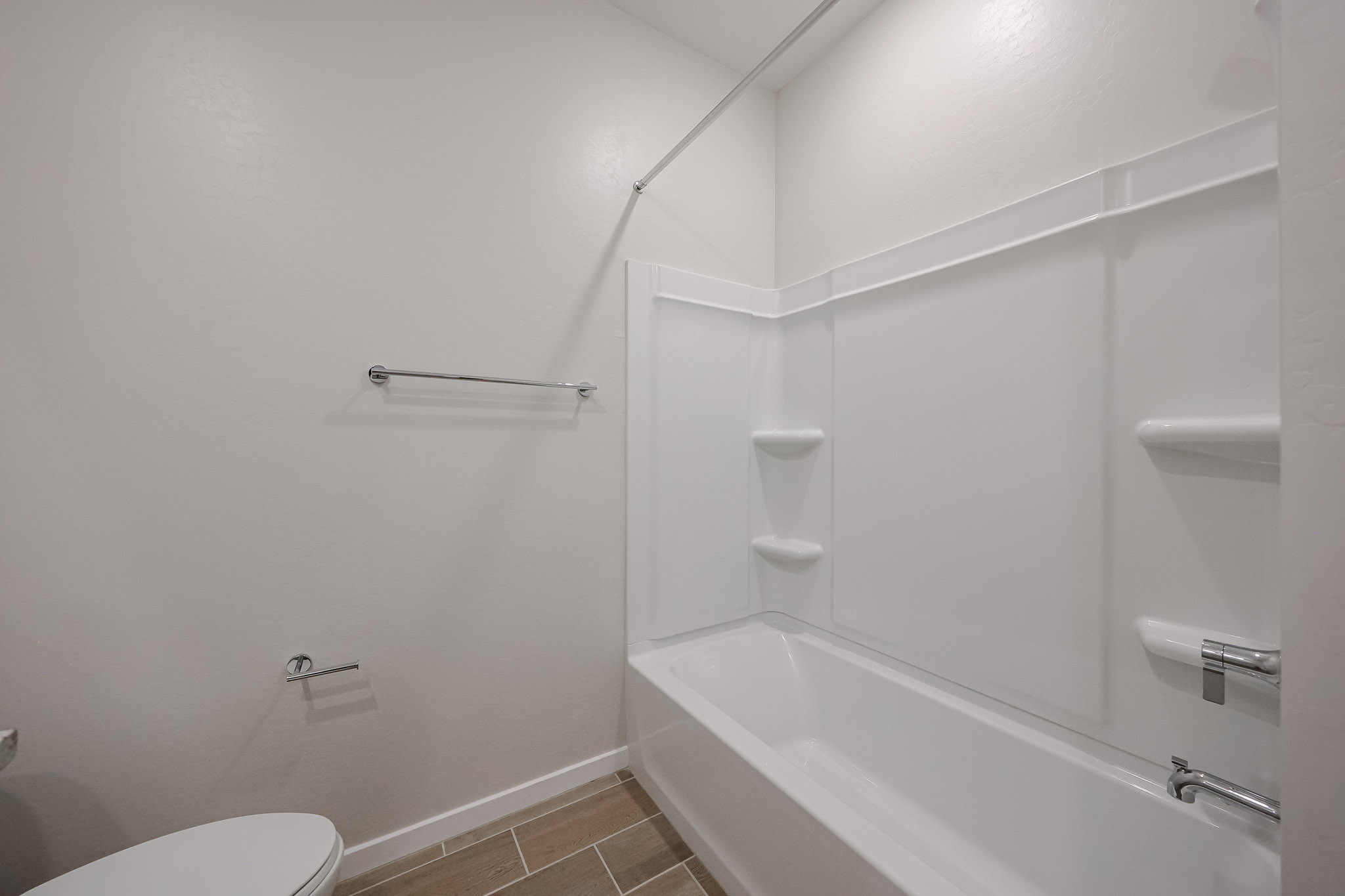 A bathroom with a bathtub toilet and shower.