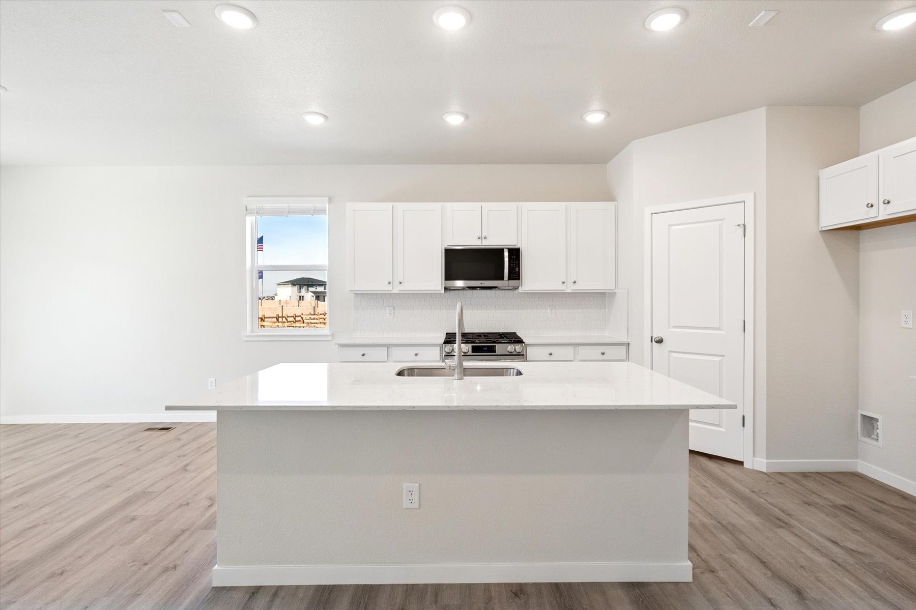 A kitchen with white cabinets.