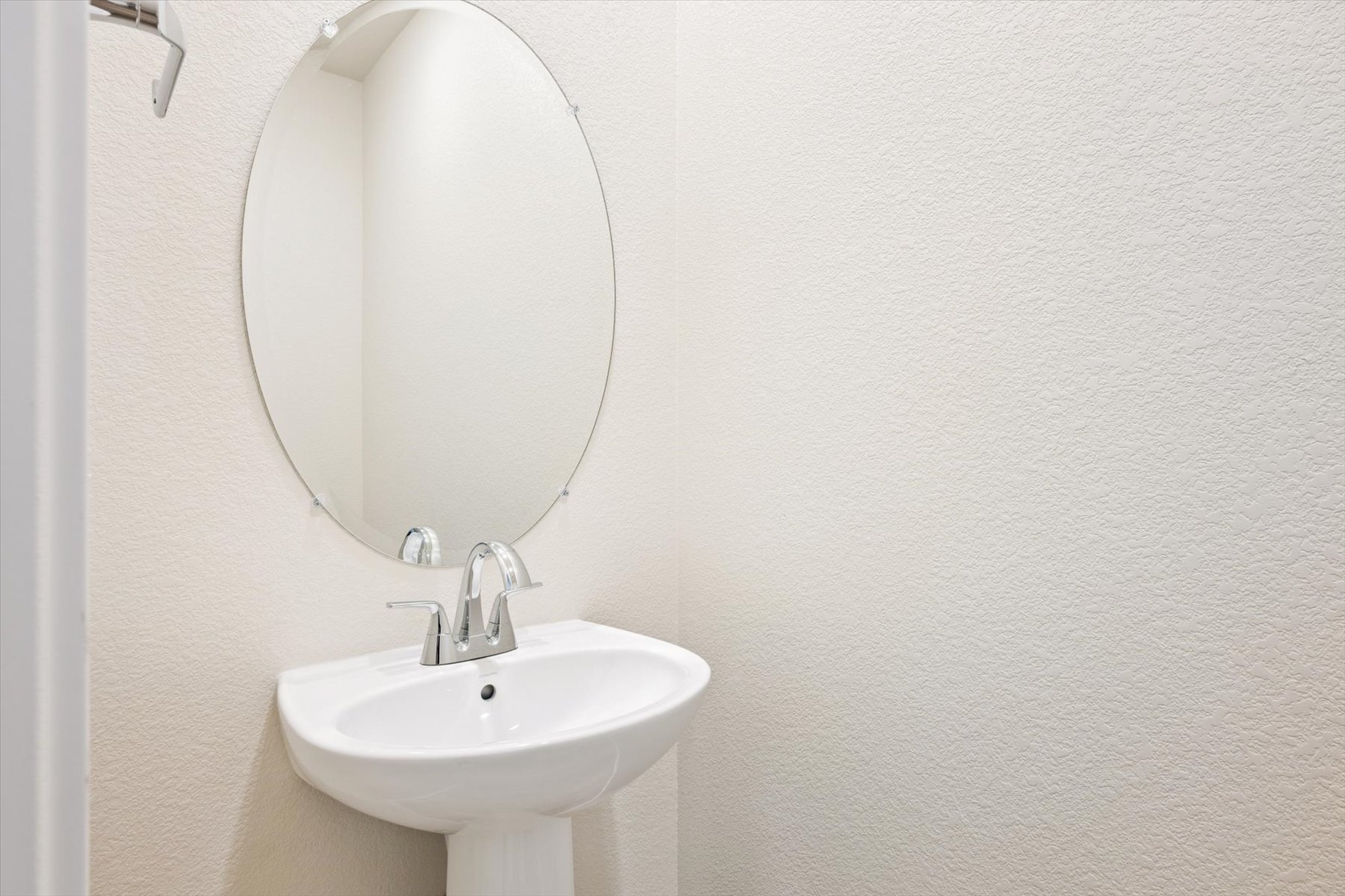 A mirror above a sink.