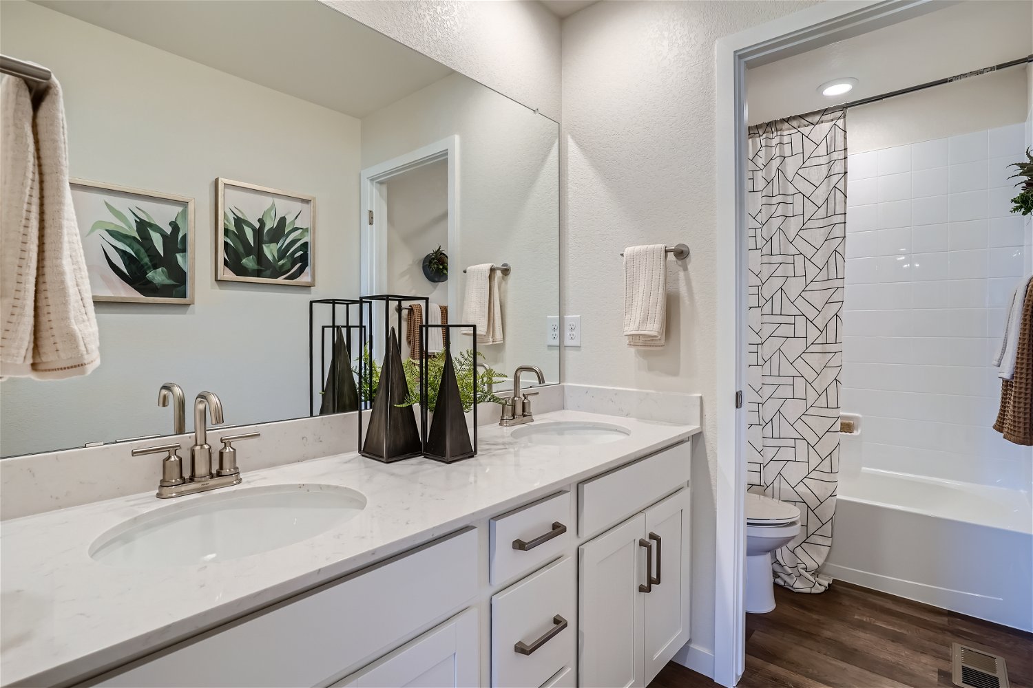 A bathroom with a sink toilet and shower.