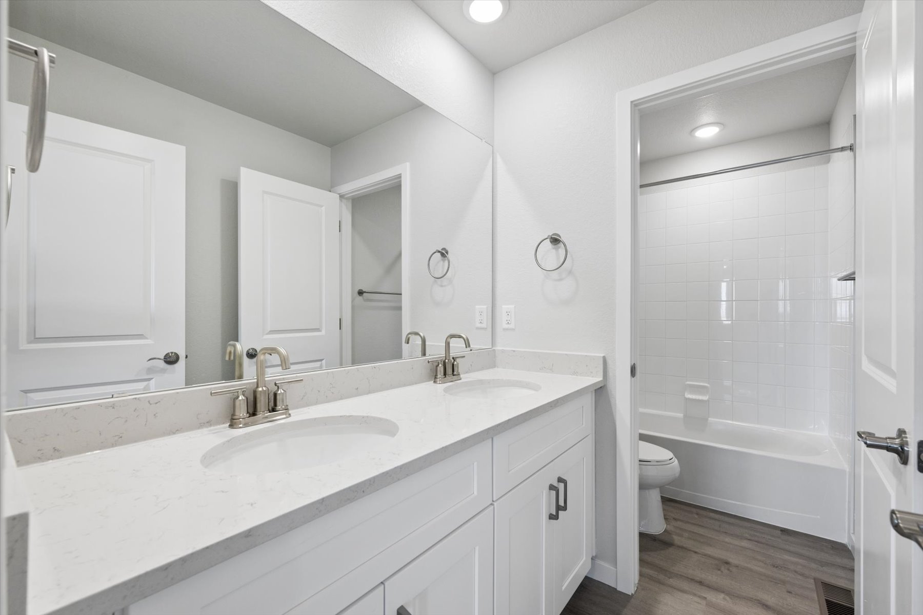 A bathroom with a tub sink and toilet.