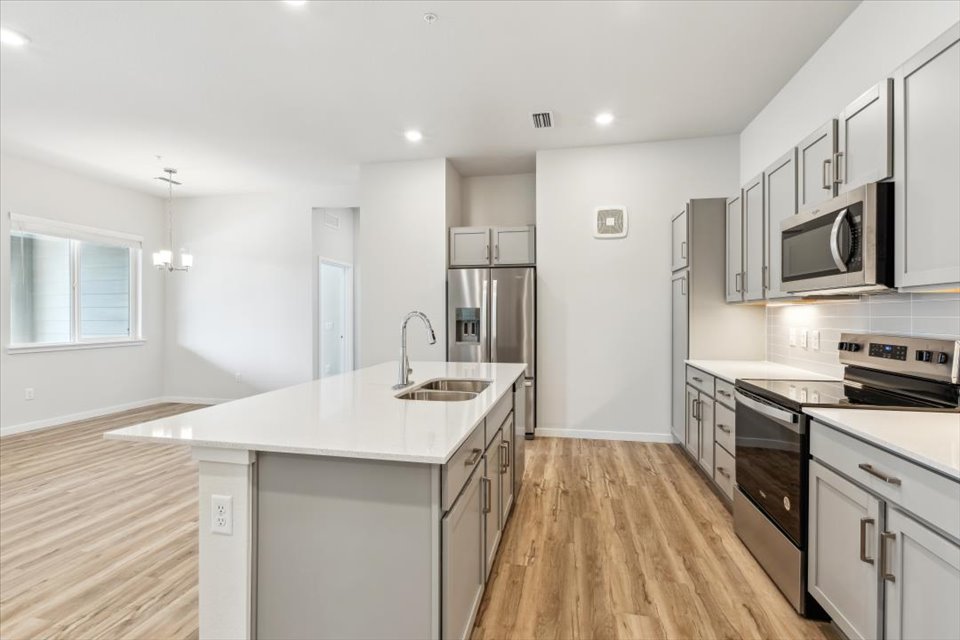 A kitchen with white cabinets.