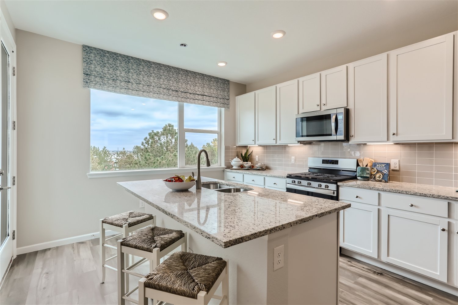 A kitchen with white cabinets.