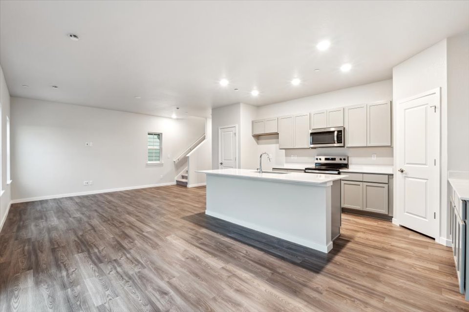 A kitchen with white cabinets.