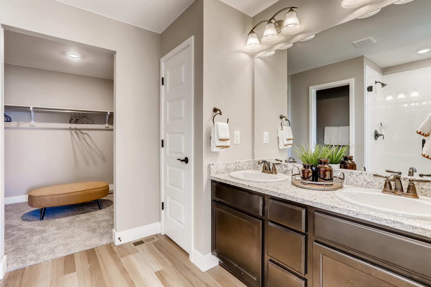 A bathroom with a large mirror.