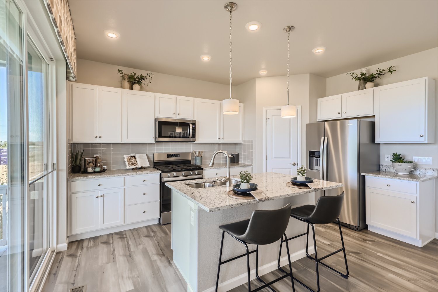 A kitchen with white cabinets.