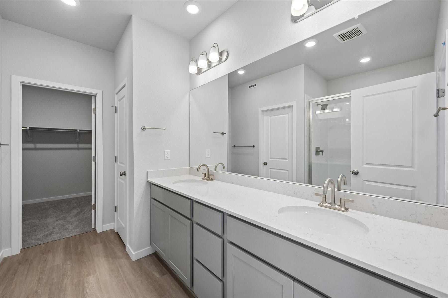 A bathroom with a large mirror.