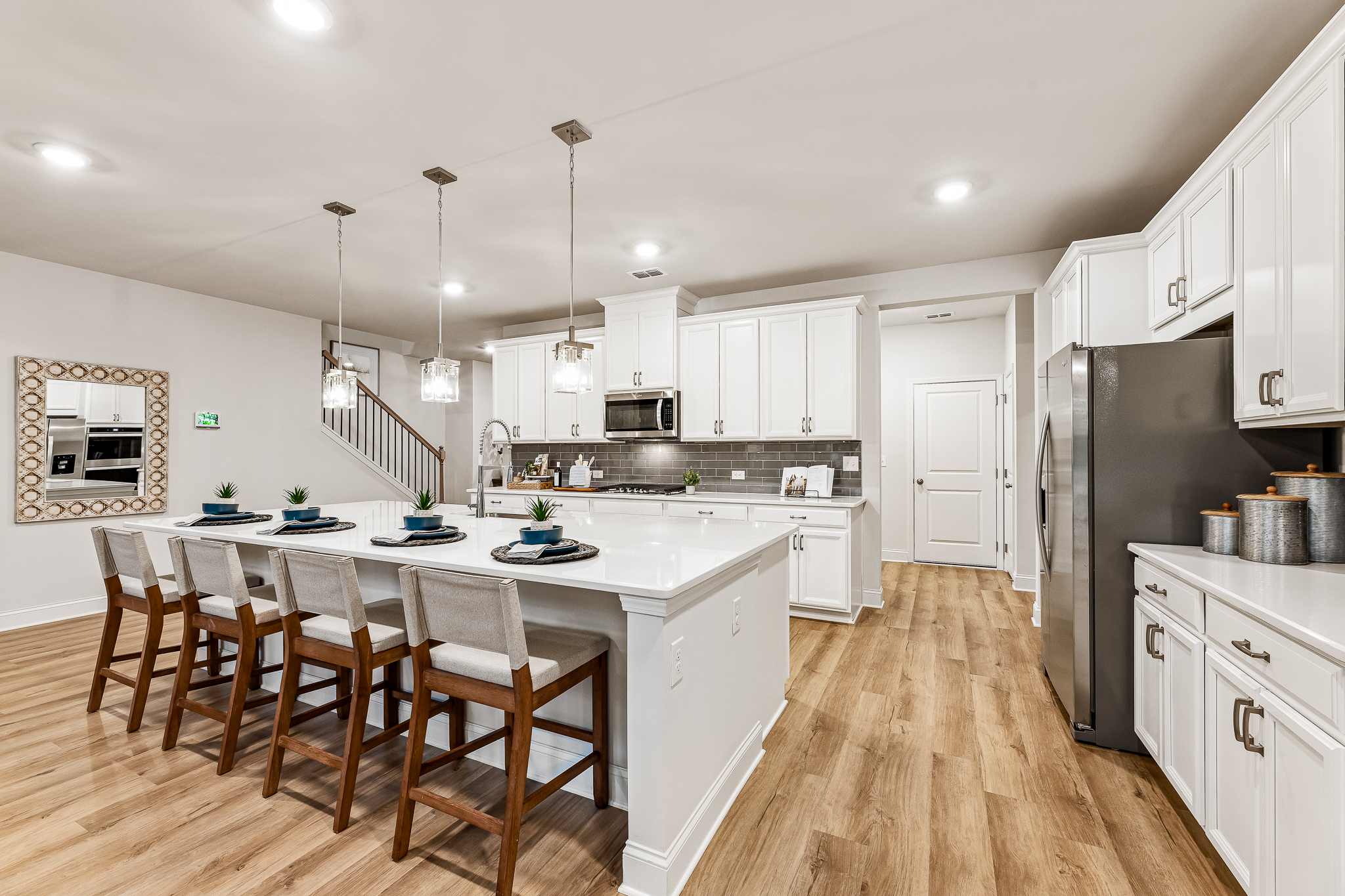 A kitchen with white cabinets.