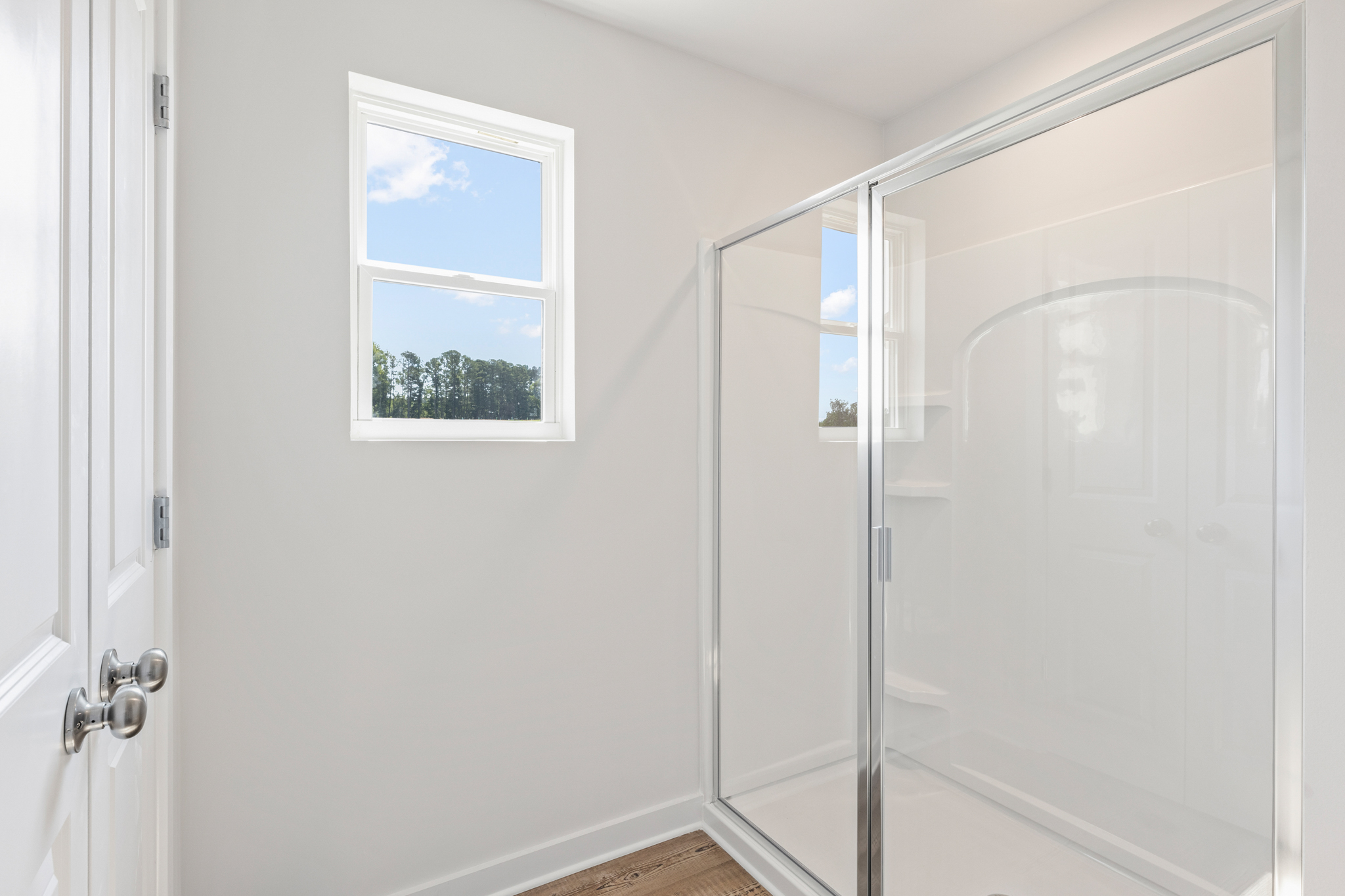 A shower with a glass door.