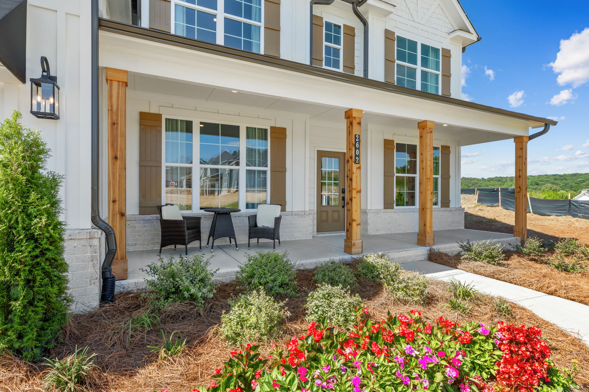 A house with a patio and a flower bed.