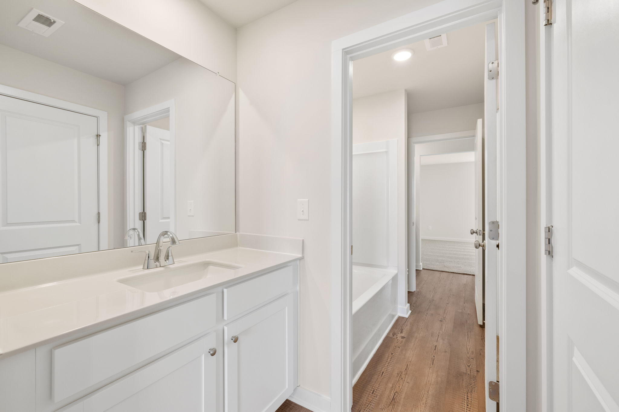 A bathroom with a sink and a shower.