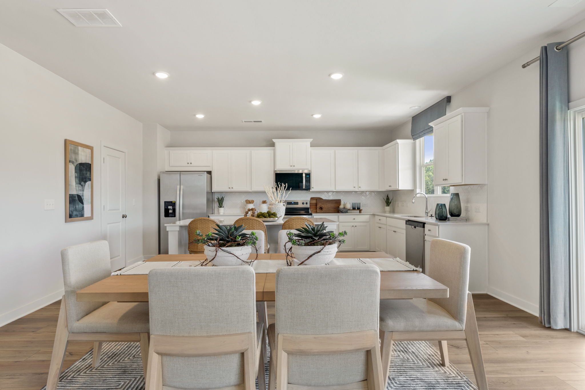 A kitchen with a dining table.
