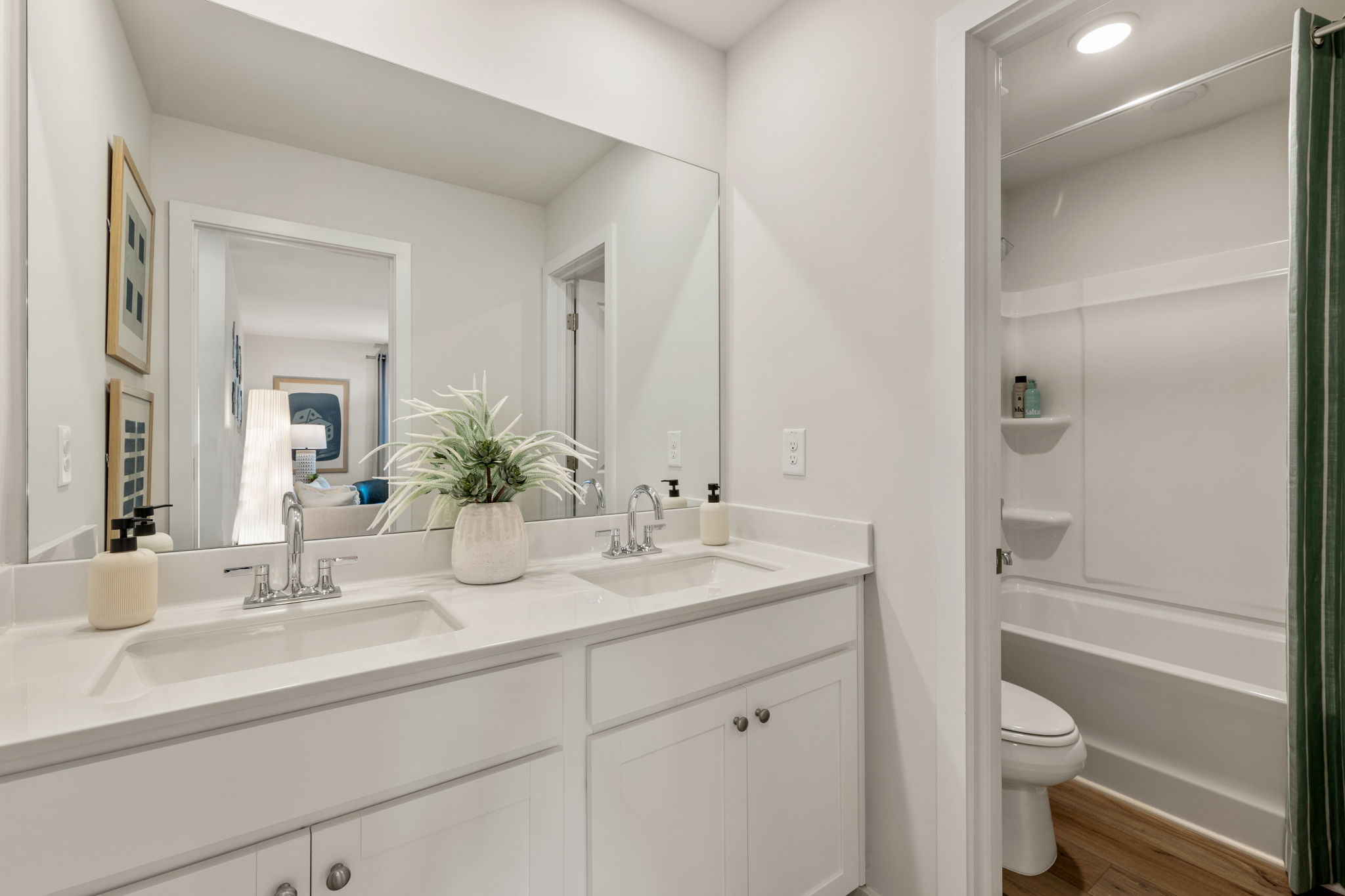 A bathroom with a tub sink and toilet.