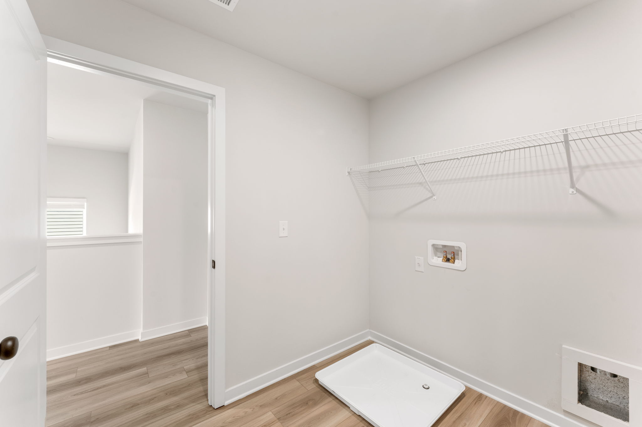 A white room with a shower and a sink.