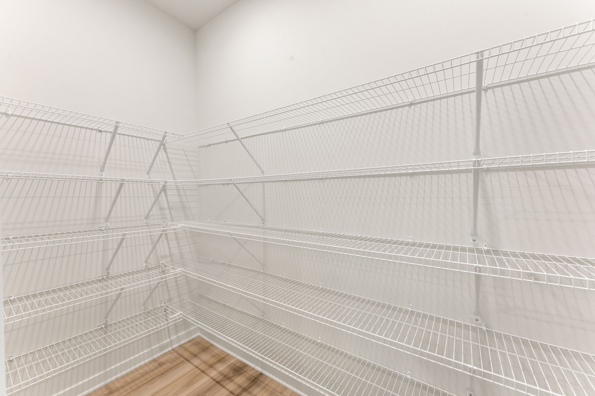 A white staircase with white walls.