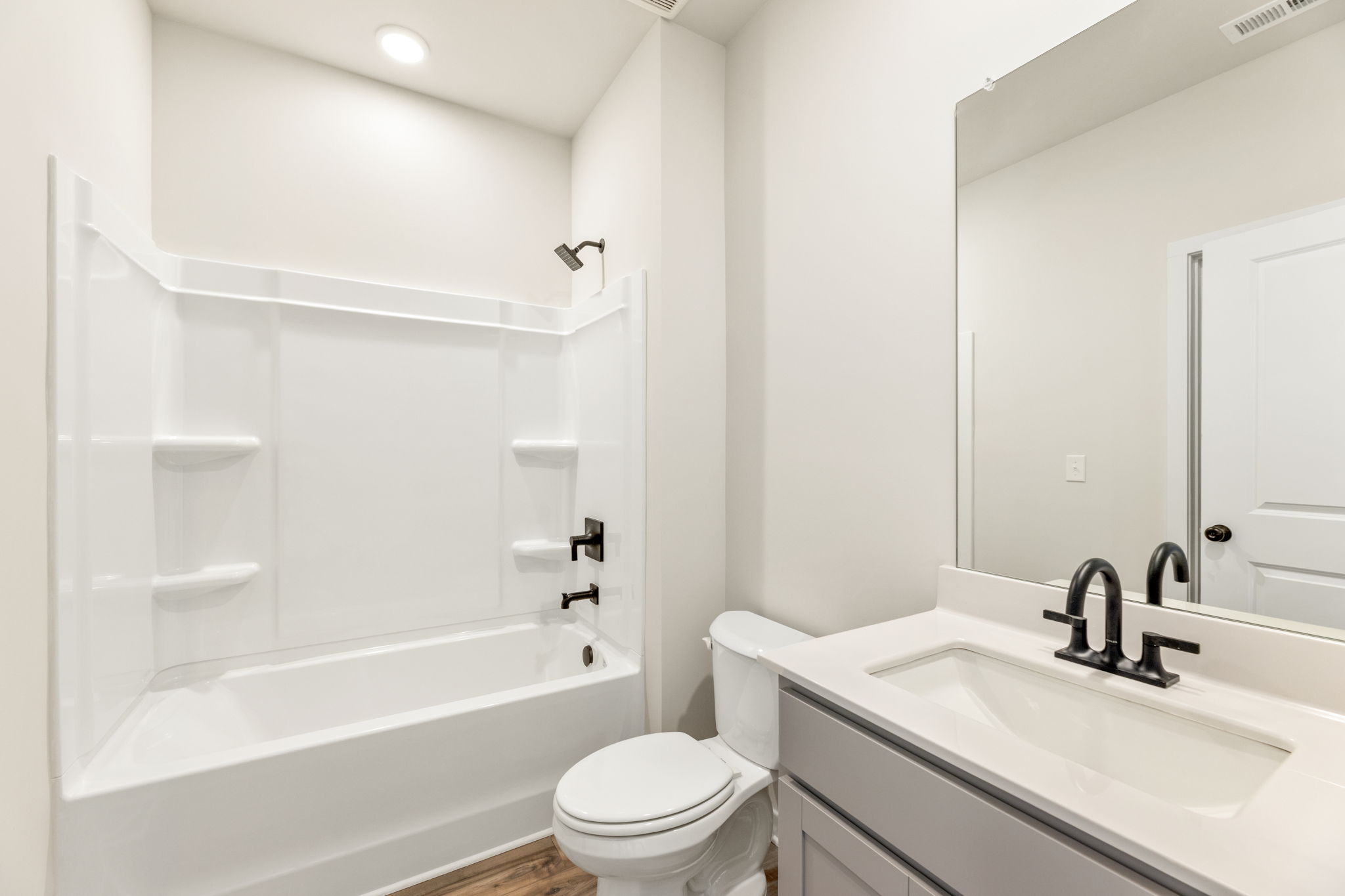A bathroom with a tub sink and toilet.
