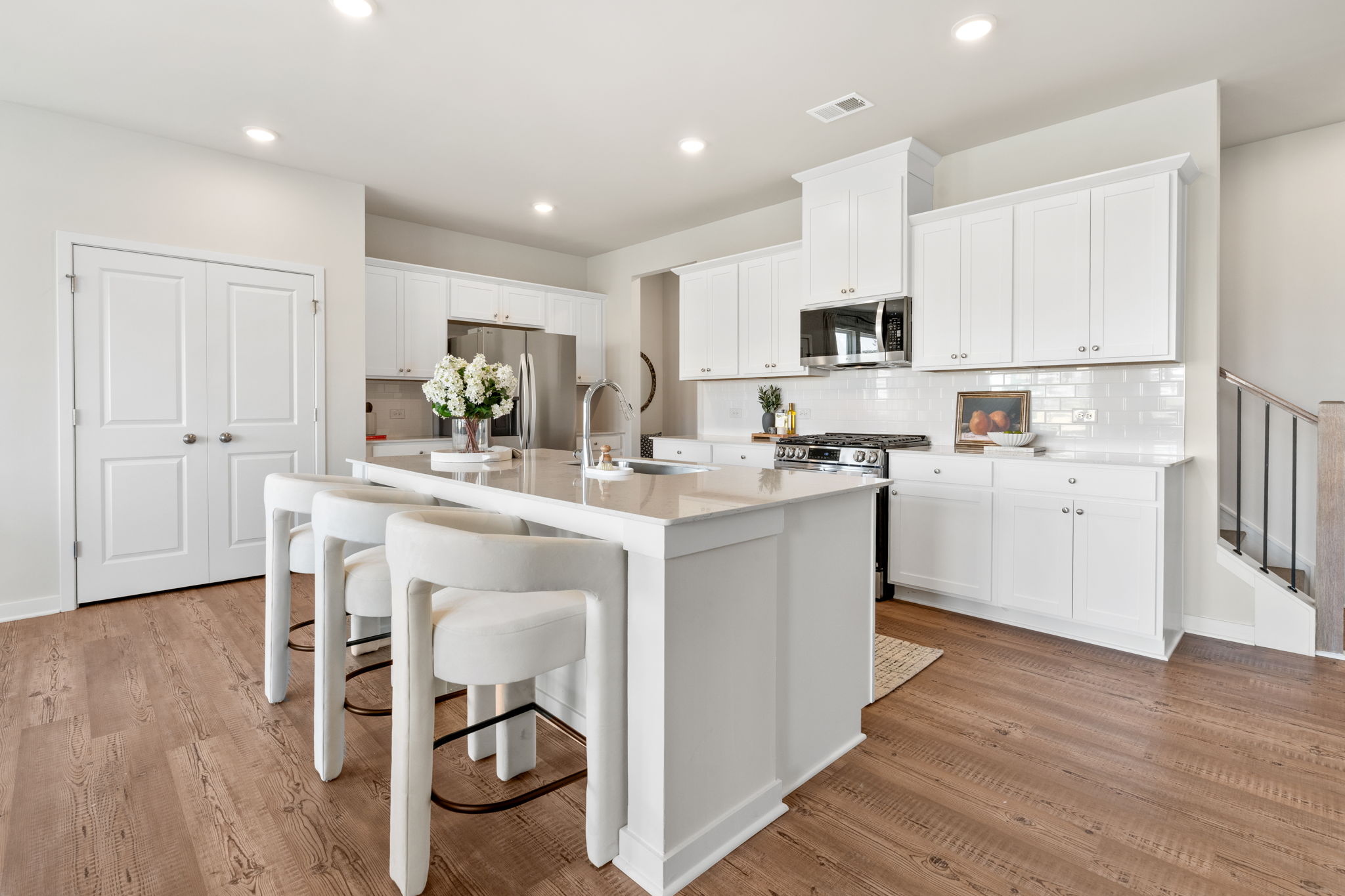 A kitchen with white cabinets.