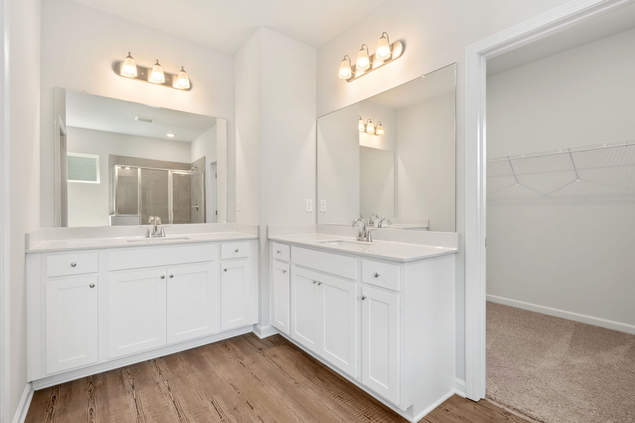 A bathroom with white cabinets.