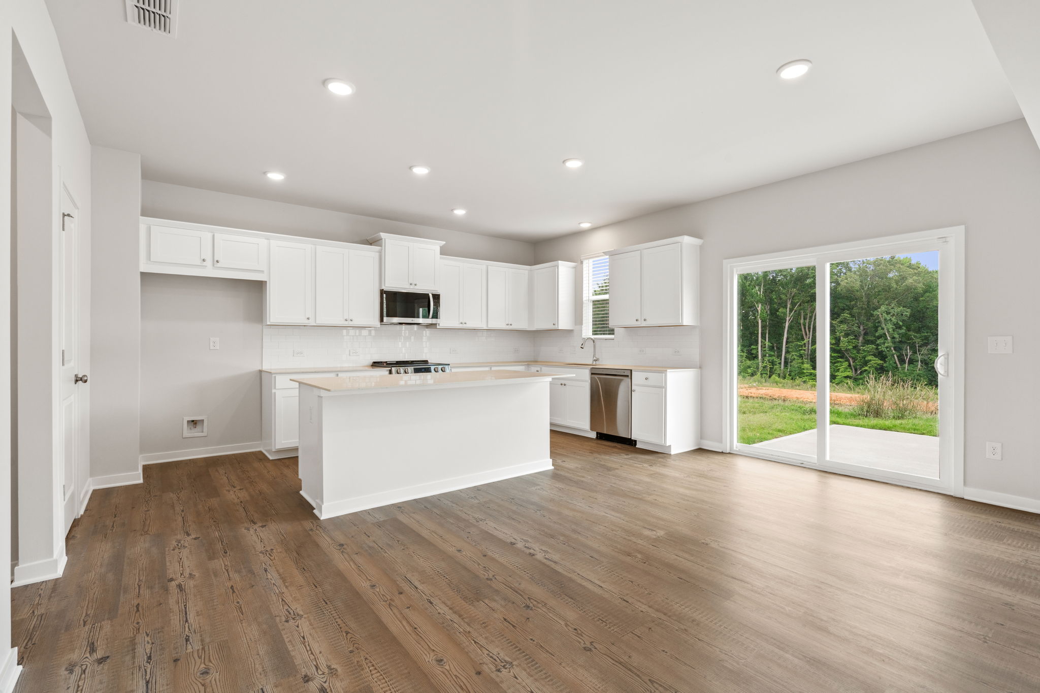 A kitchen with white cabinets.