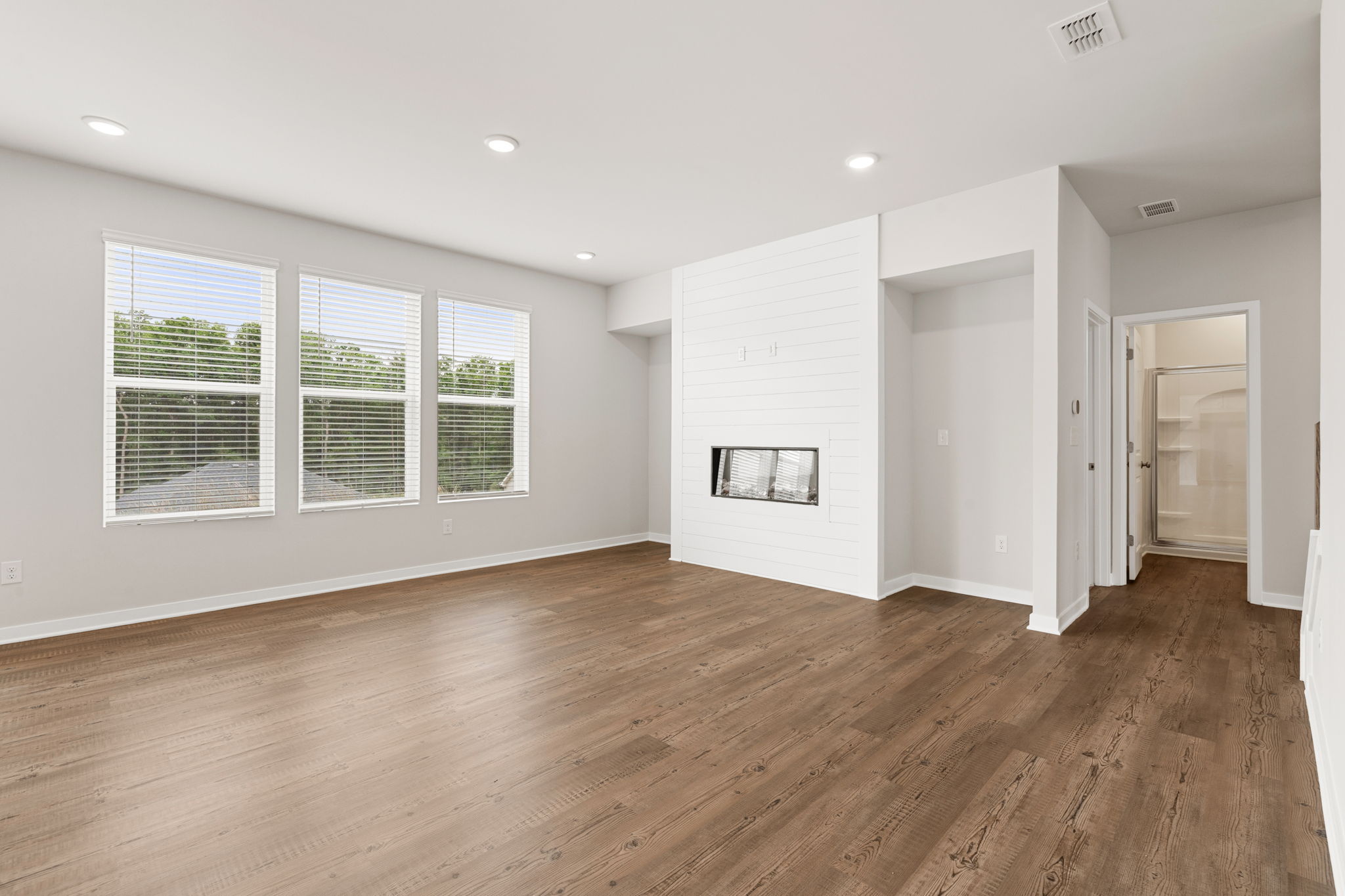 A room with a wood floor and white walls.