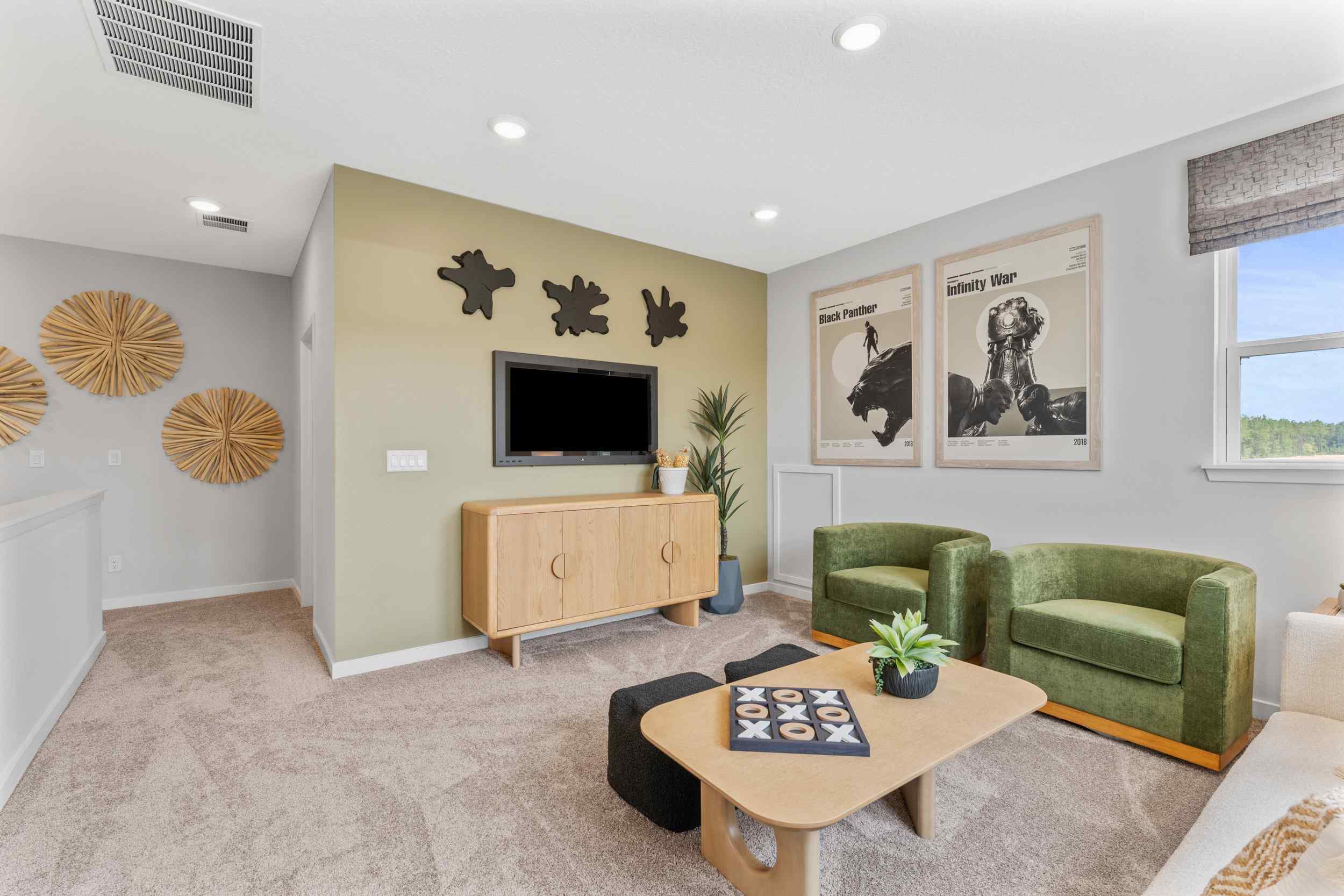 Silverbell II Model Home Loft with Green Chairs and TV at Camden Woods in Kingsland, GA