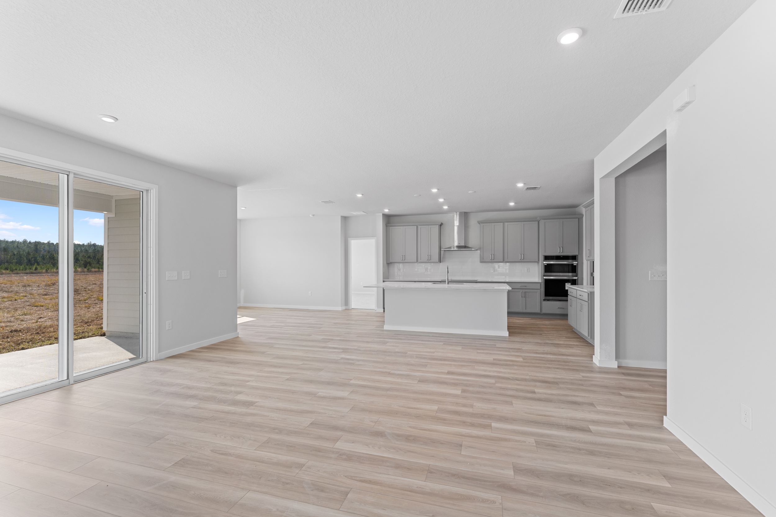 Lot 596 Open Living Area with Kitchen and Dining Nook in Back at NorthShore