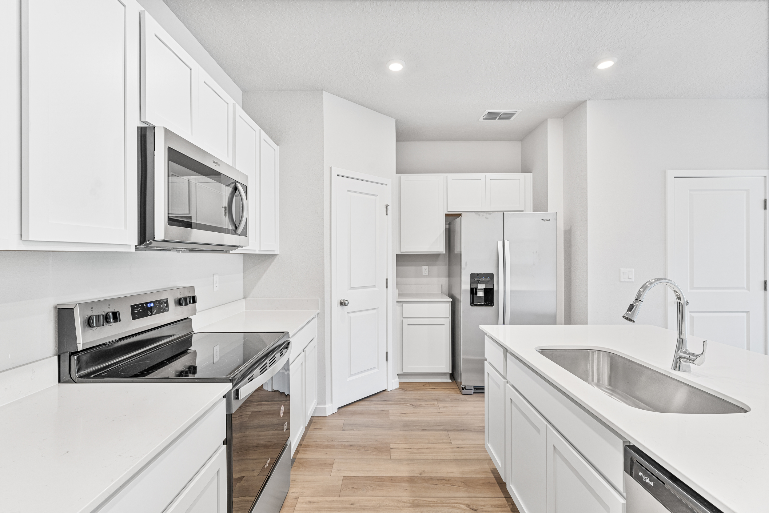 Lot 19 Townhome Kitchen with White Cabinets at The Villas at Bishop Oaks