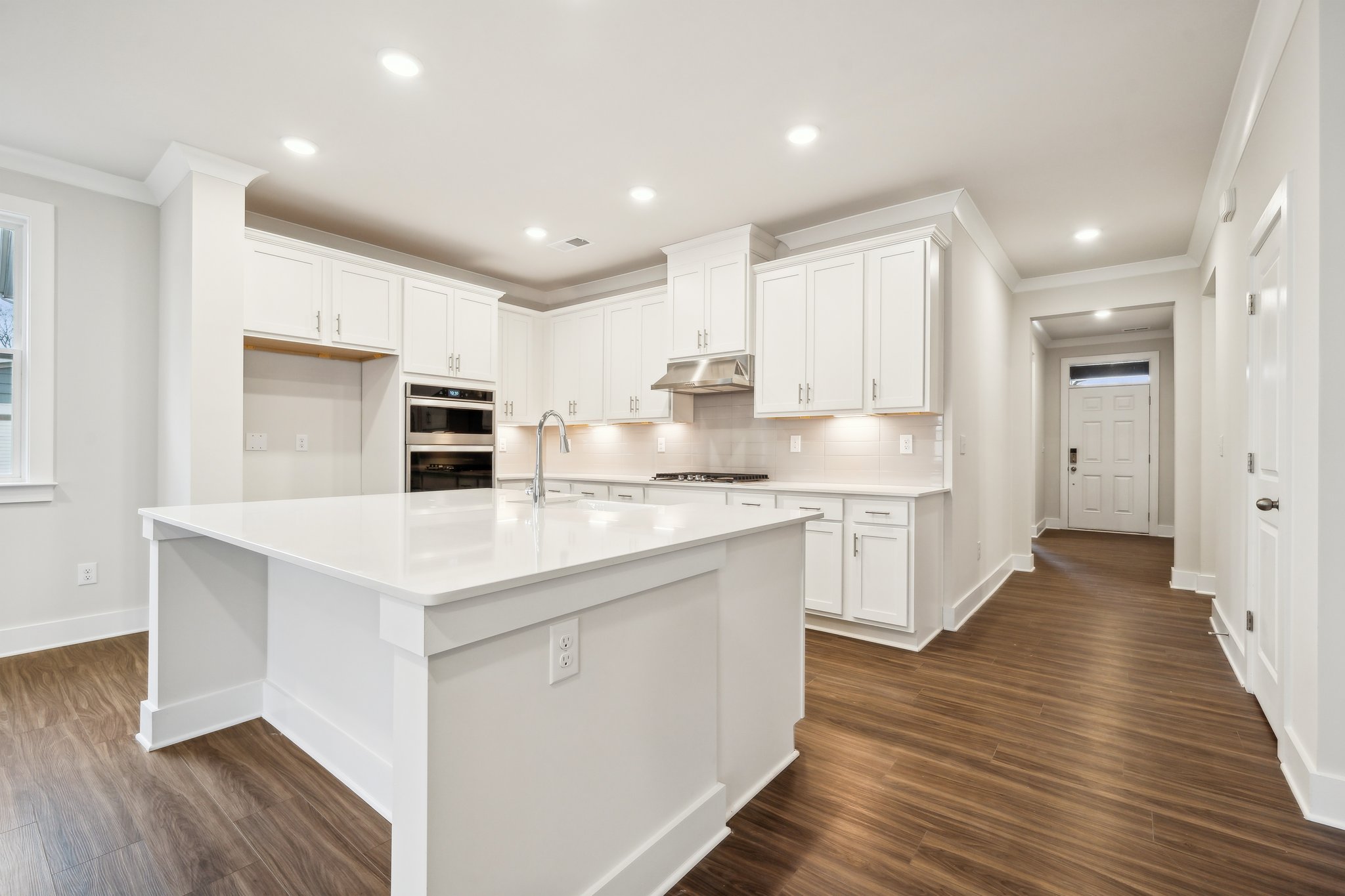 A kitchen with white cabinets.